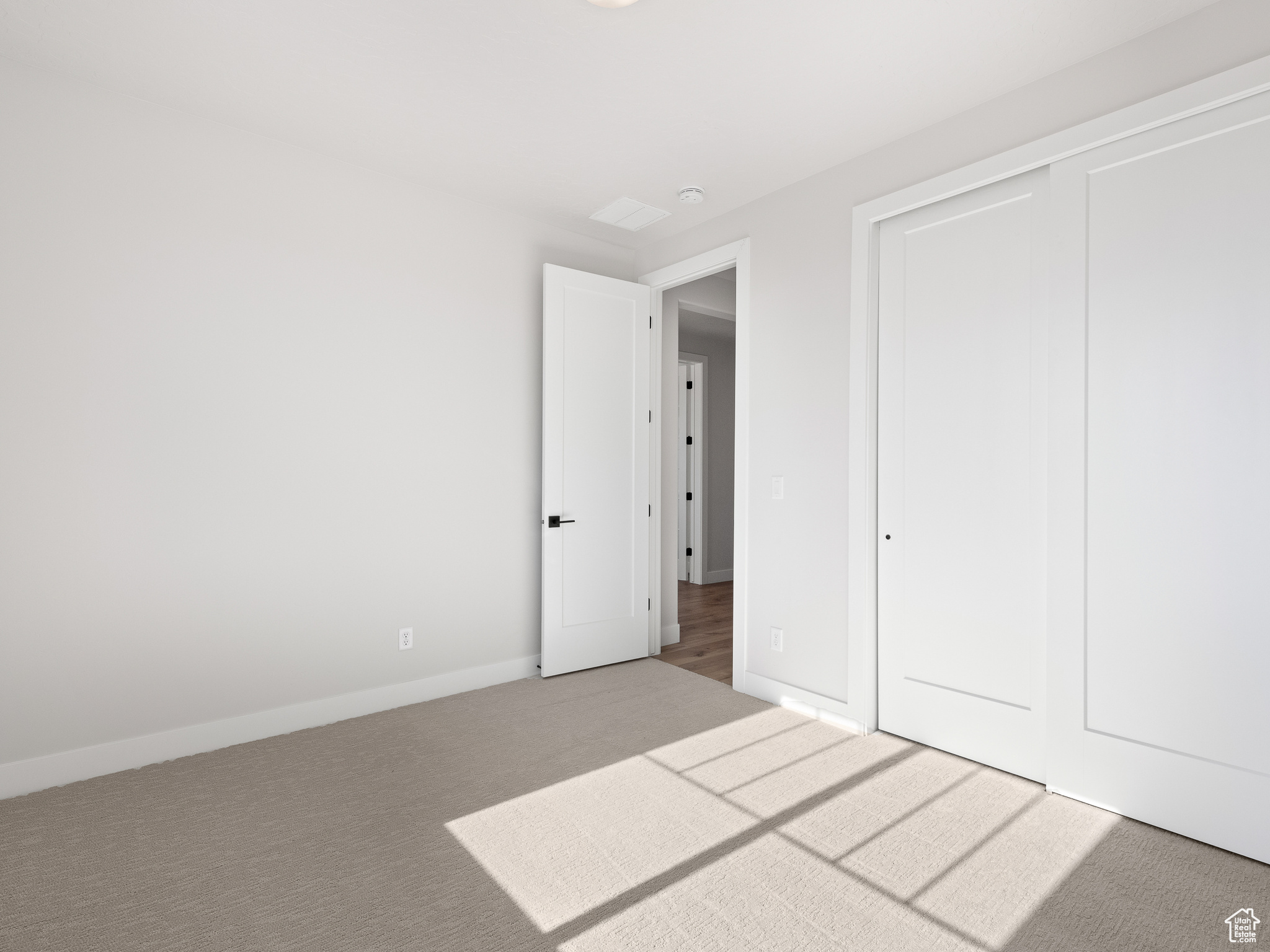 Unfurnished bedroom featuring carpet and a closet. This is a picture of Helena model home. Not the interior of actual home.