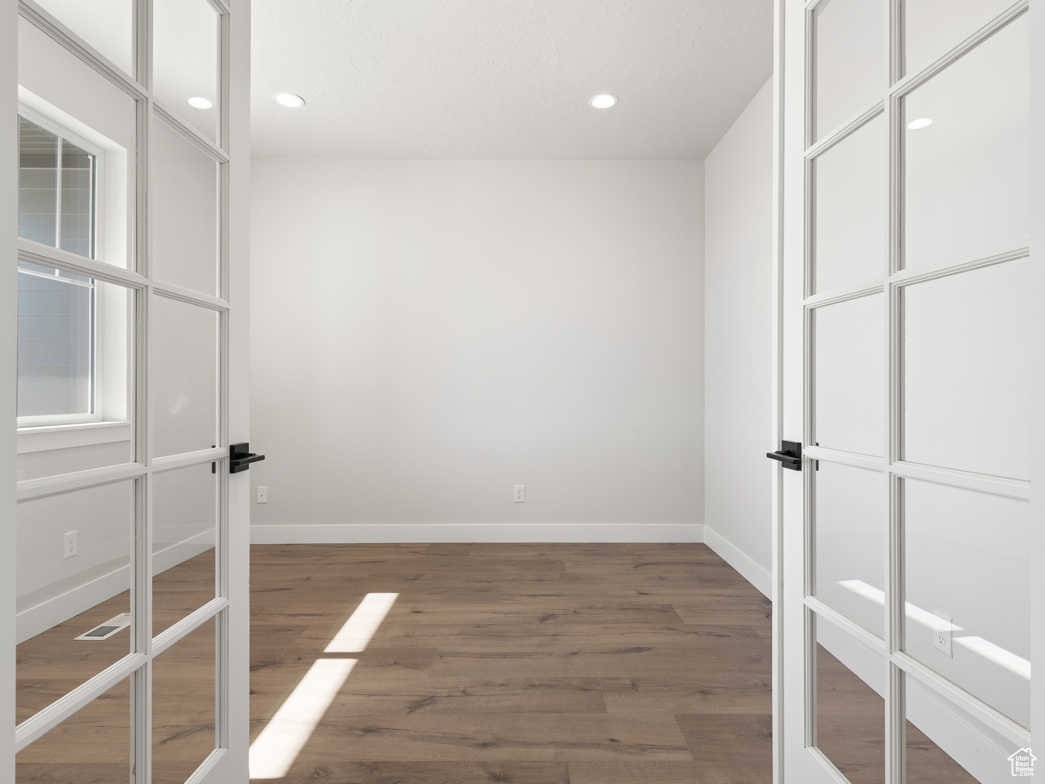 Empty room with wood-type flooring. This is a picture of Helena model home. Not the interior of actual home.