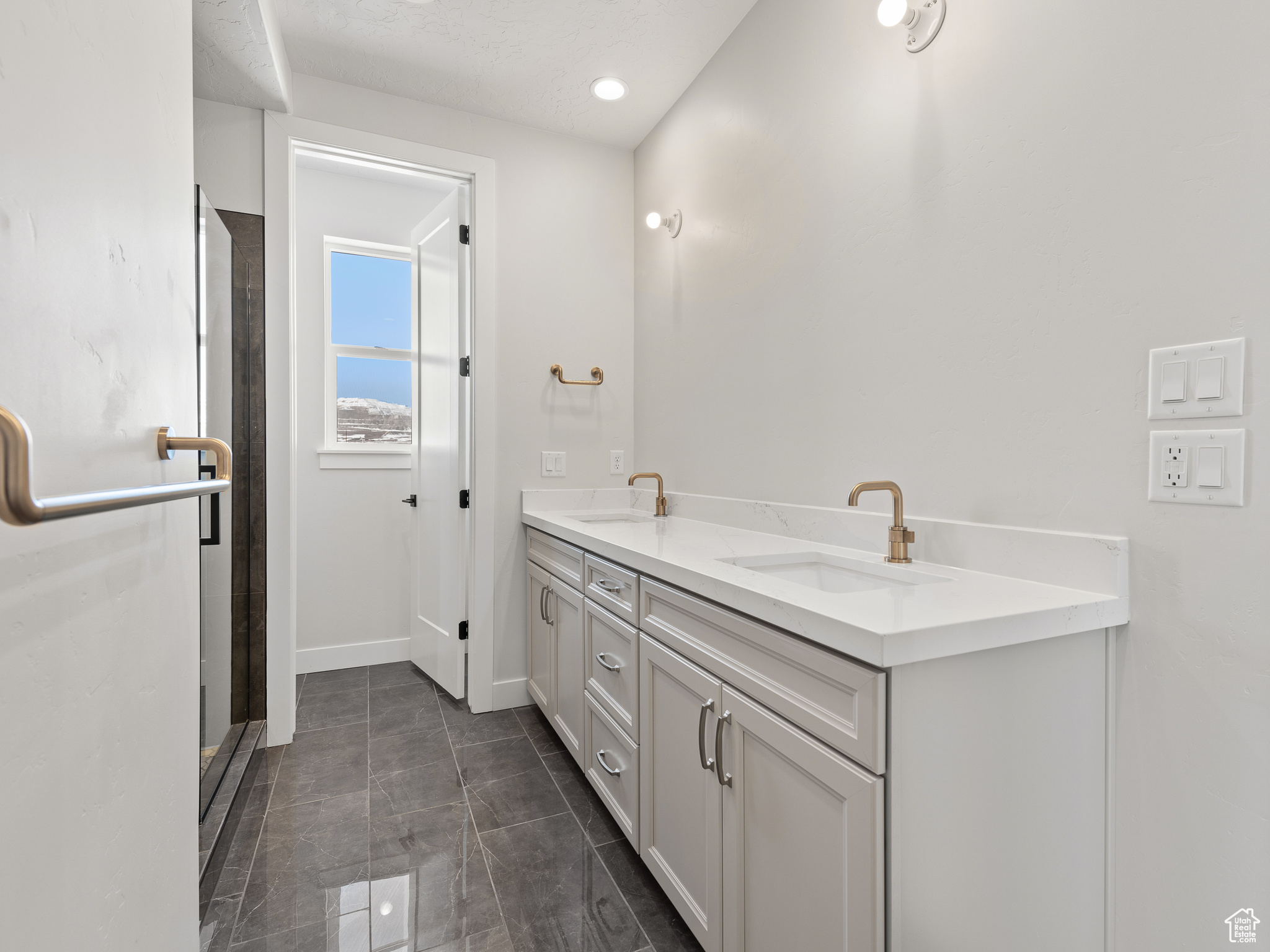 Bathroom with tile flooring and double sink vanity. This is a picture of Helena model home. Not the interior of actual home.