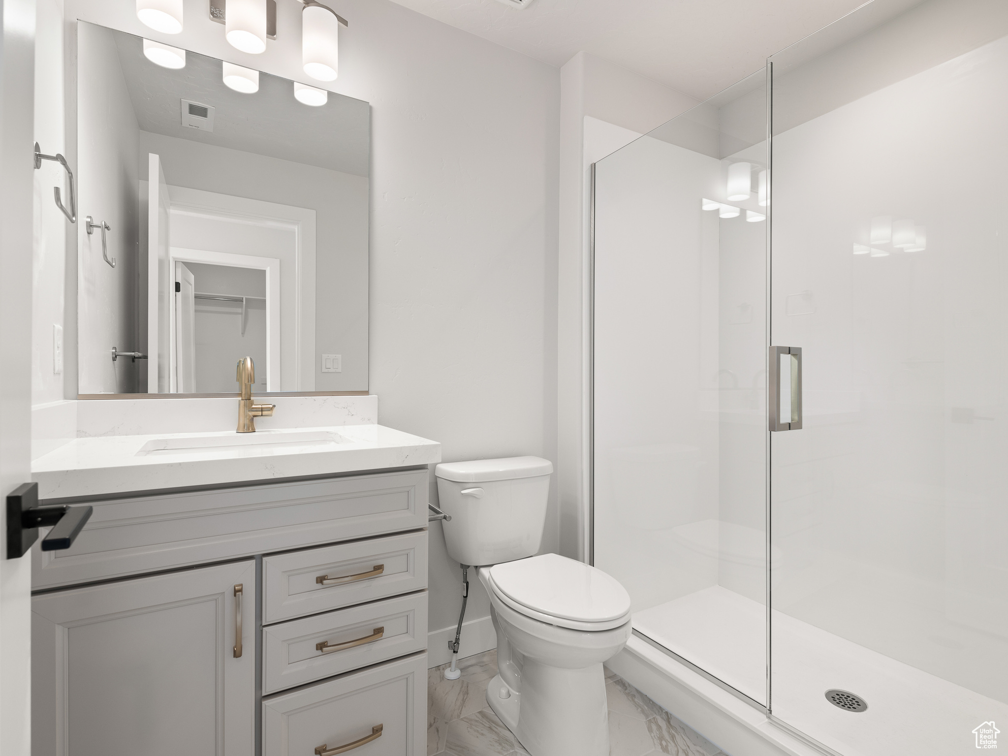 Bathroom featuring tile flooring, an enclosed shower, vanity, and toilet. This is a picture of Helena model home. Not the interior of actual home.