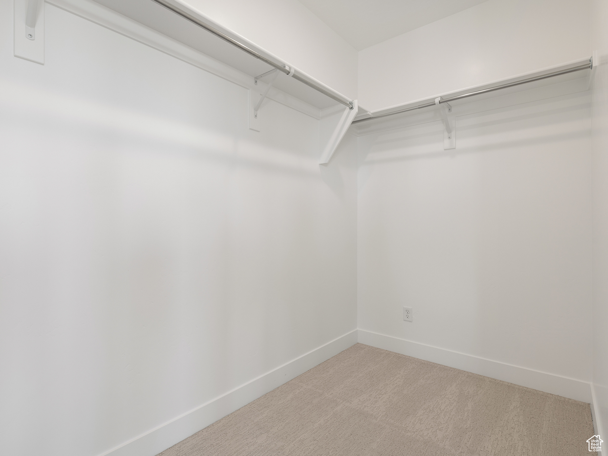 Walk in closet with carpet floors. This is a picture of Helena model home. Not the interior of actual home.