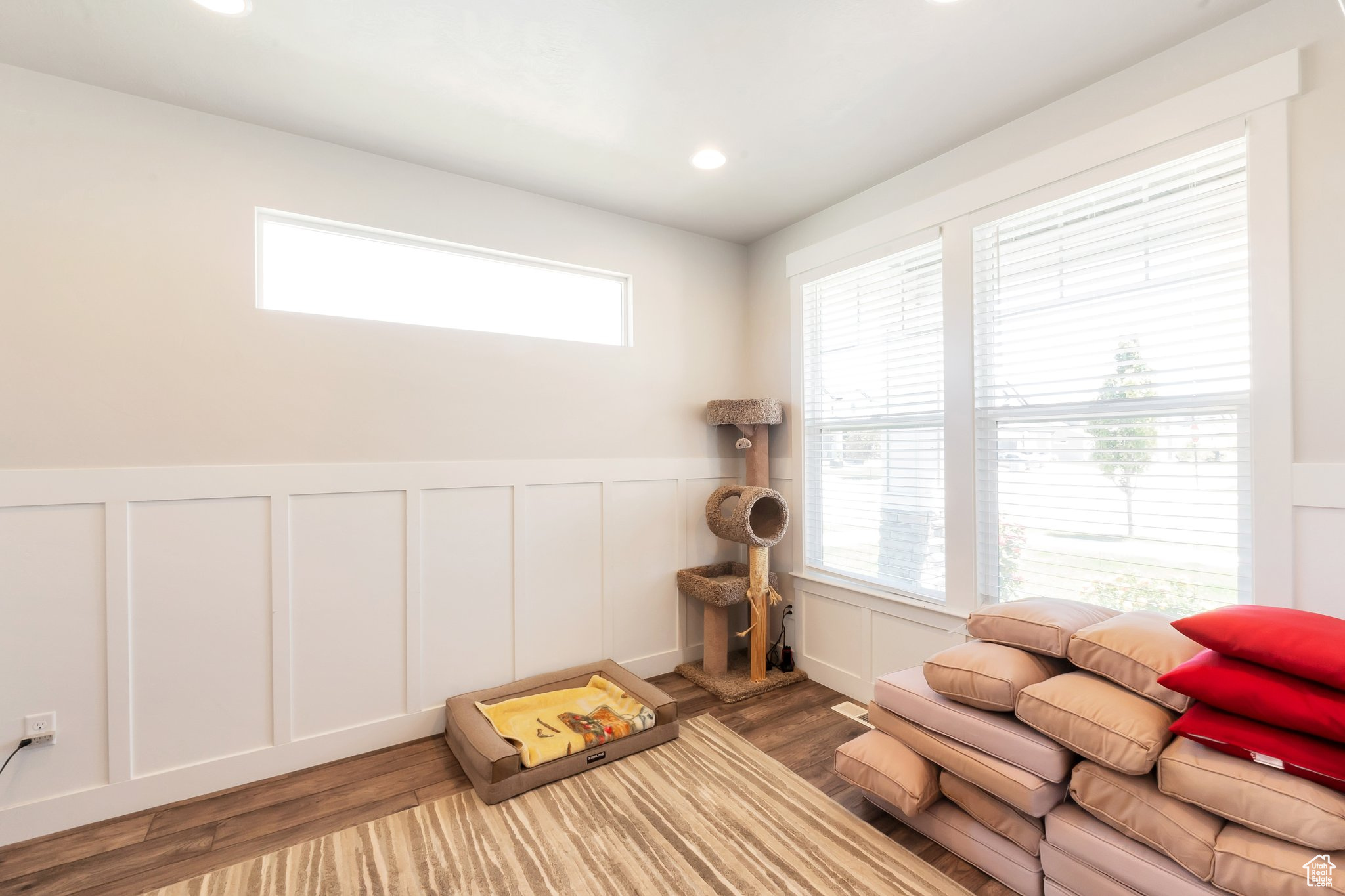 Living room with plenty of natural light and dark wood-type flooring