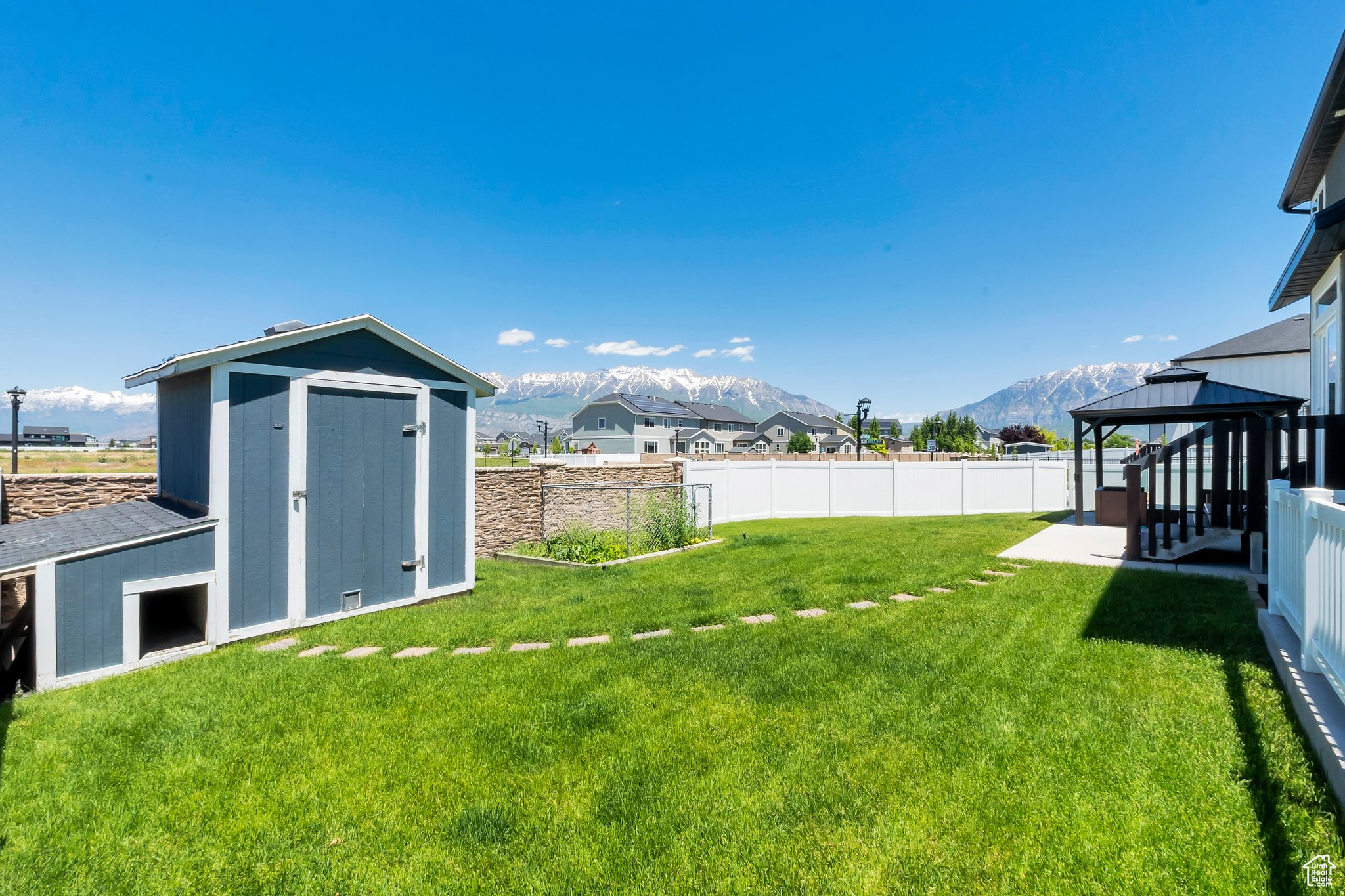 View of yard with a gazebo, a mountain view, and a shed