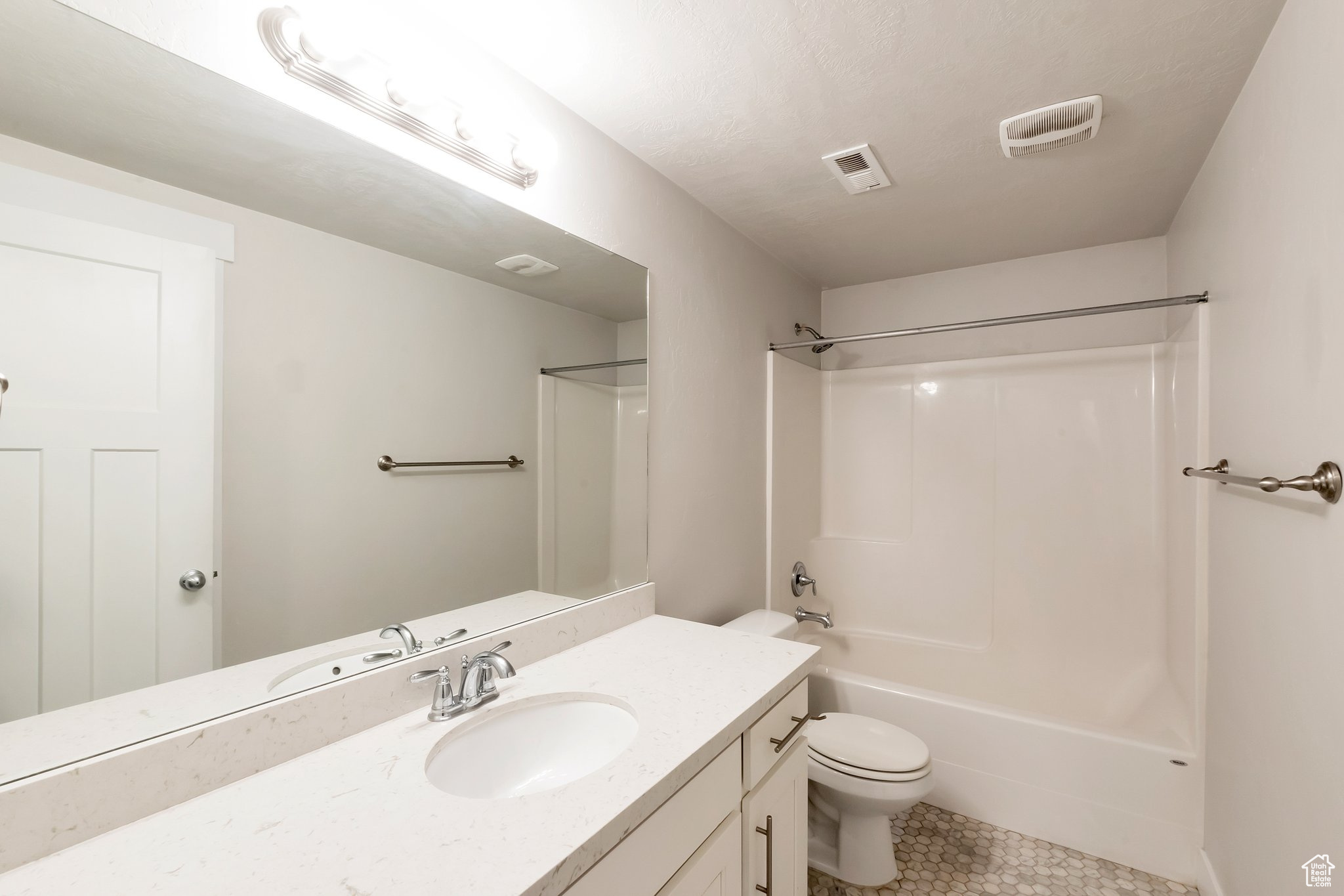 Full bathroom with tile flooring, shower / bath combination, toilet, and vanity