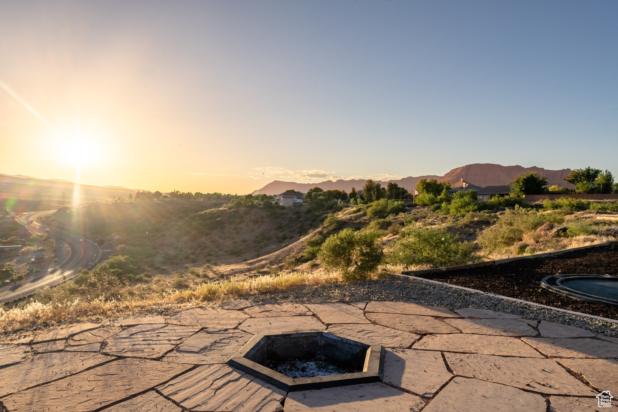 Patio terrace at dusk featuring a mountain view and a fire pit