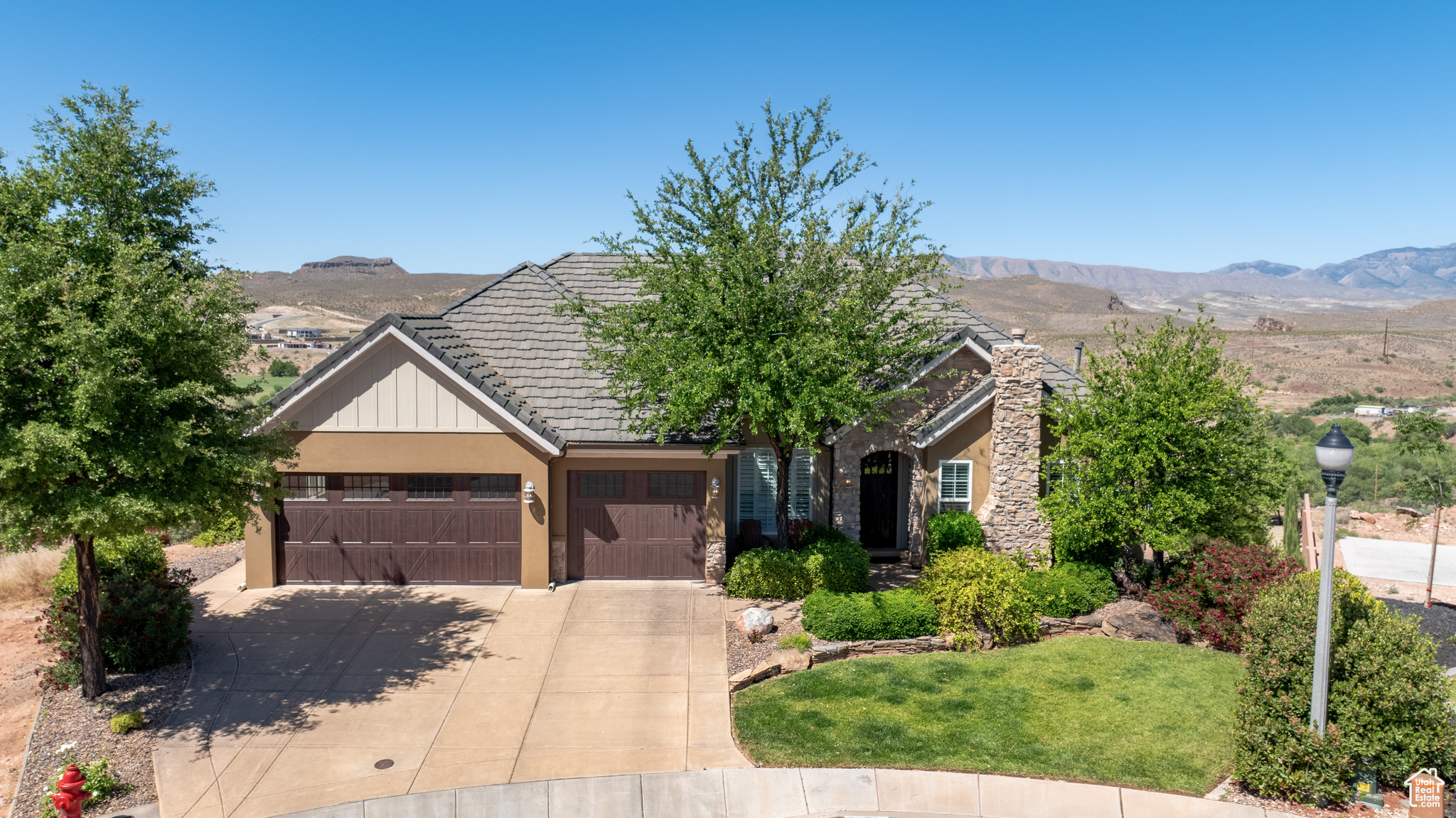 View of front of house with a garage and a mountain view