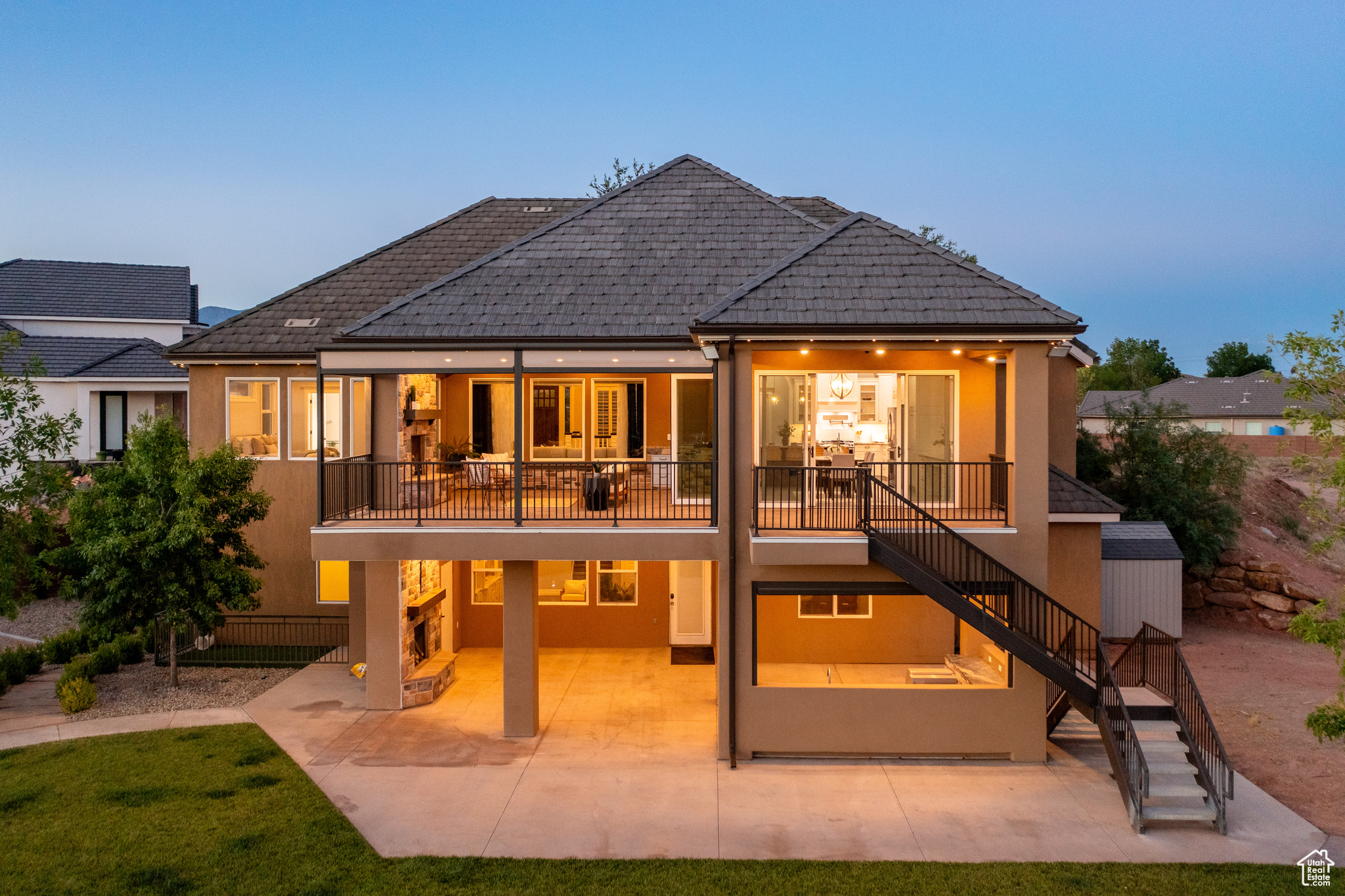 Back house at dusk featuring a patio area