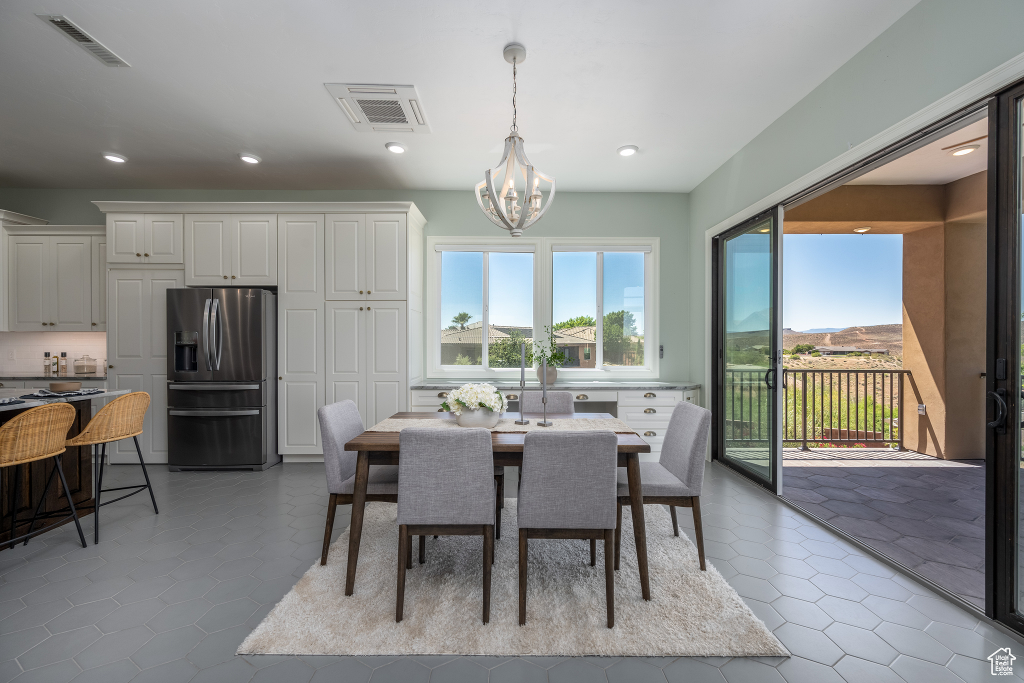 Dining area with a notable chandelier and tile flooring