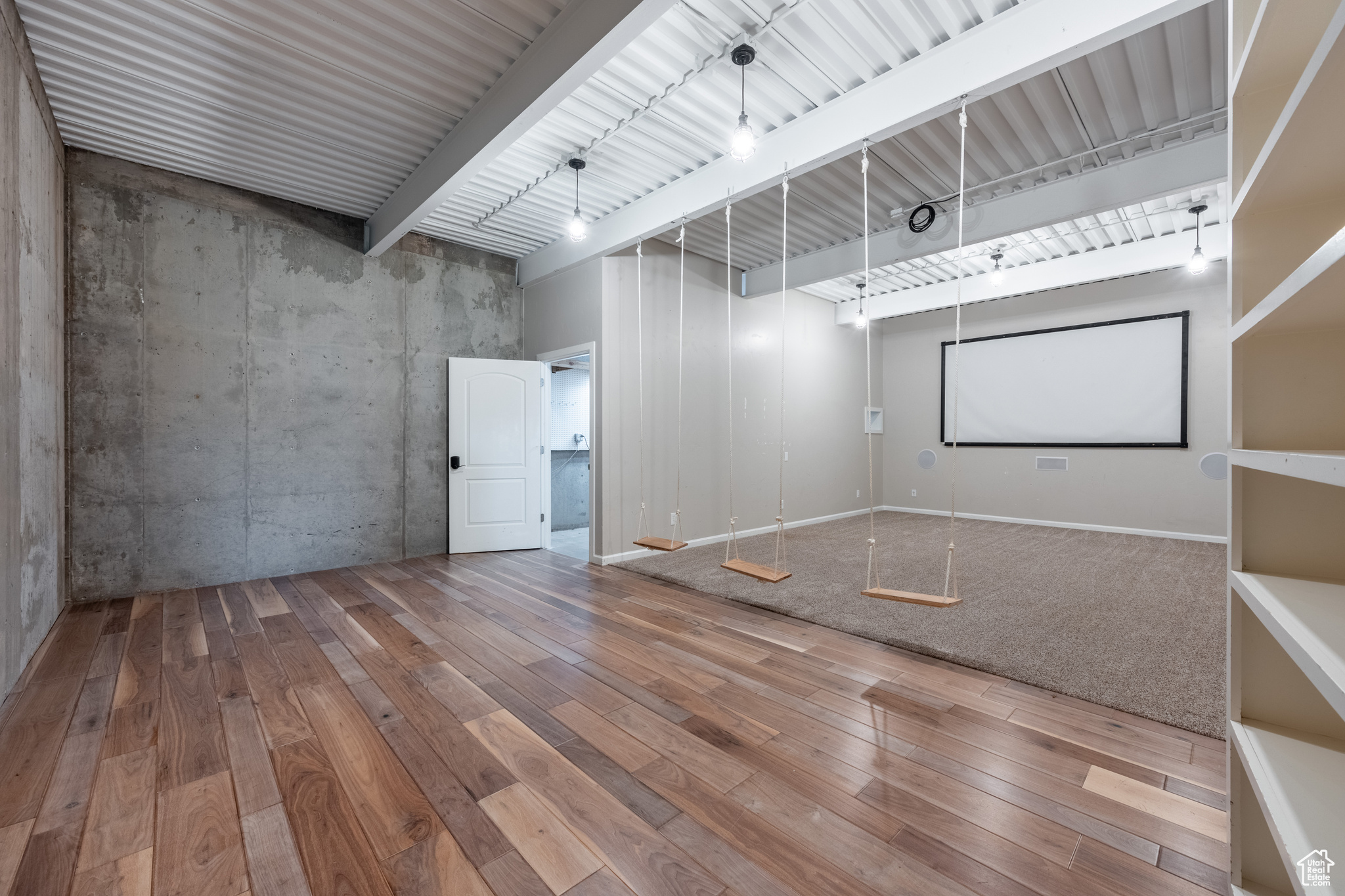 Theater room with beamed ceiling and hardwood / wood-style floors