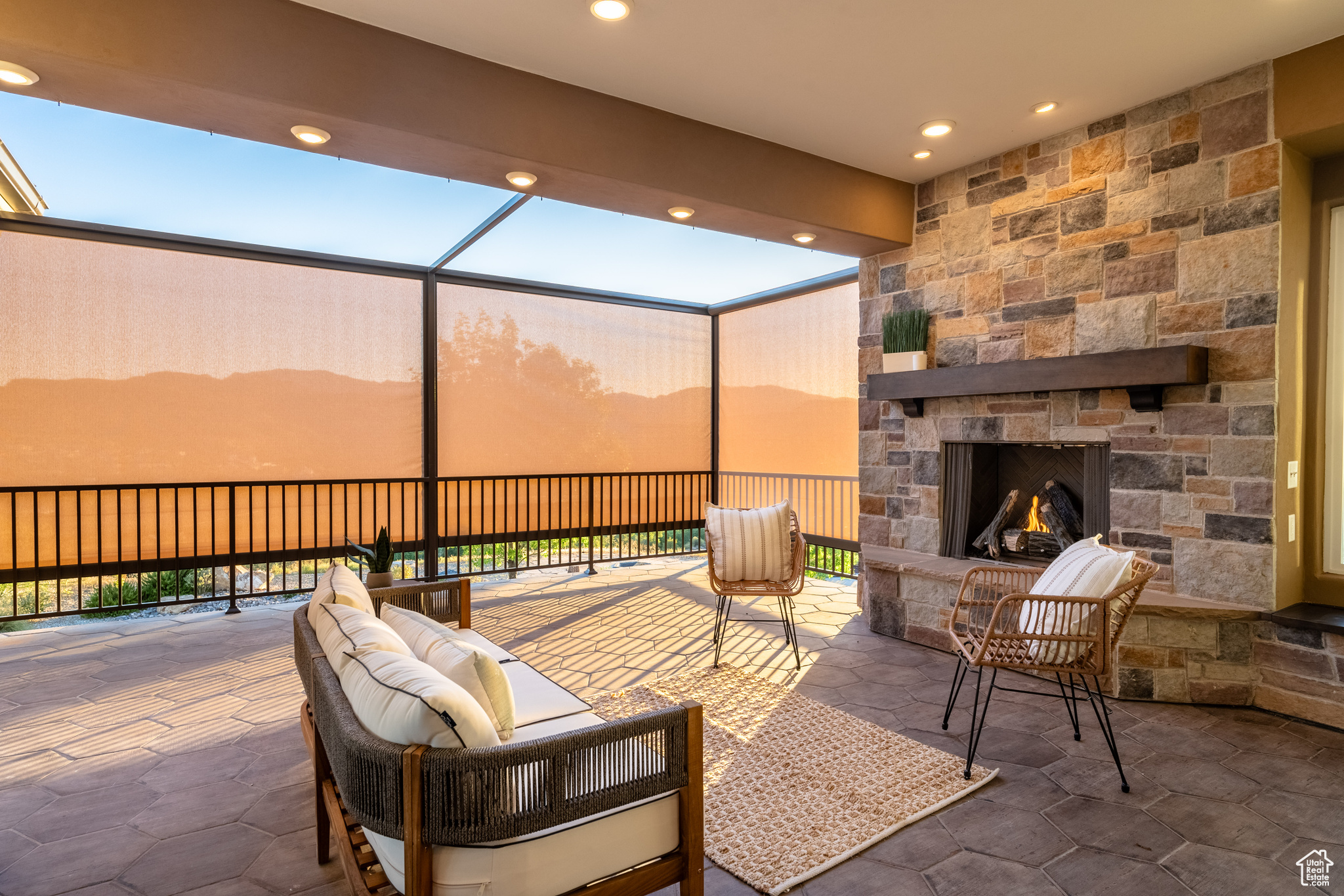 View of patio featuring an outdoor stone fireplace