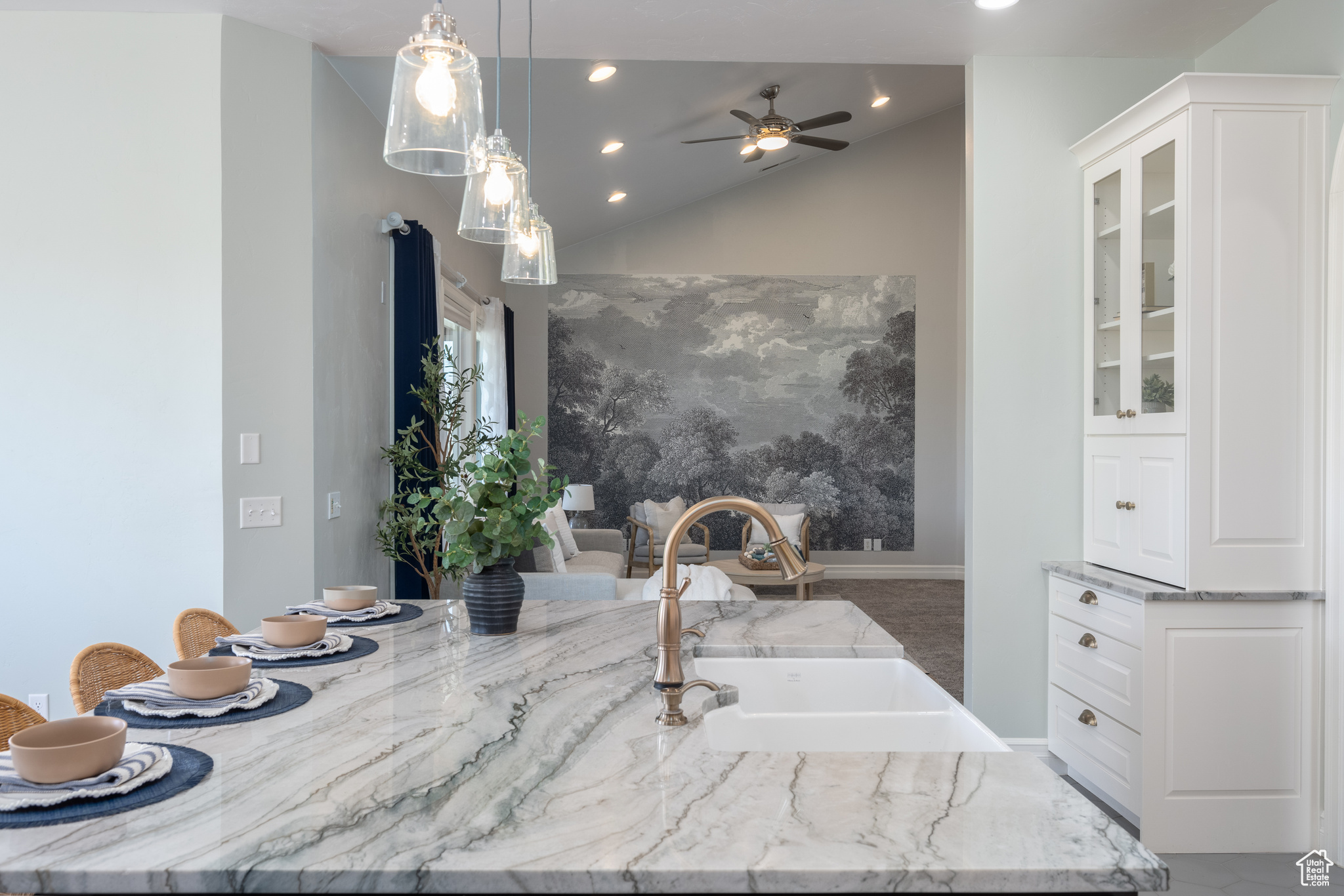 Bathroom featuring ceiling fan, sink, and lofted ceiling