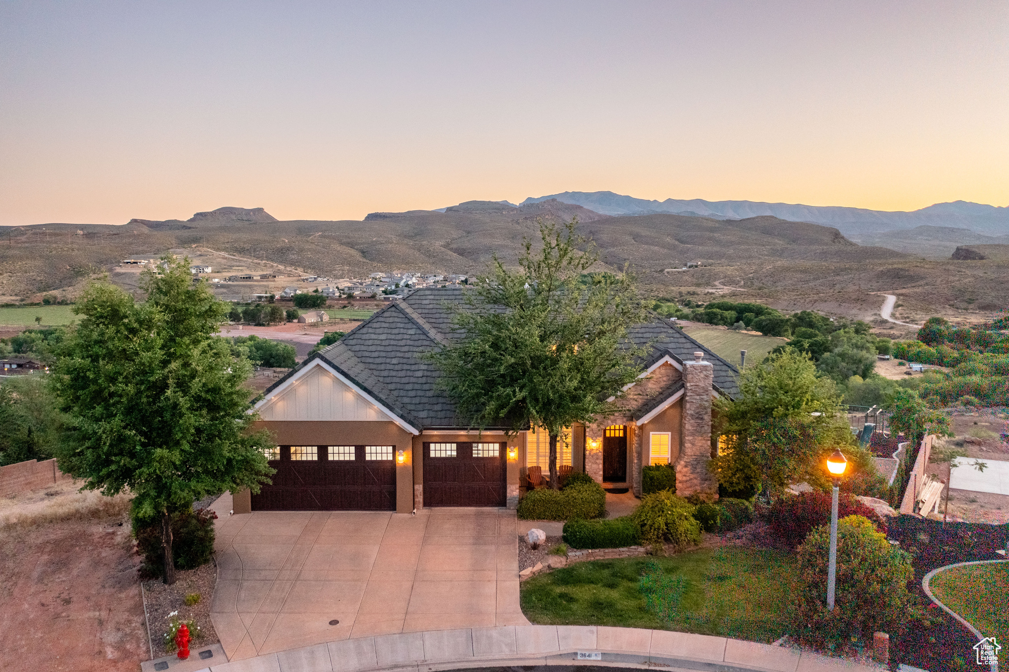 View of front facade featuring a garage and a mountain view