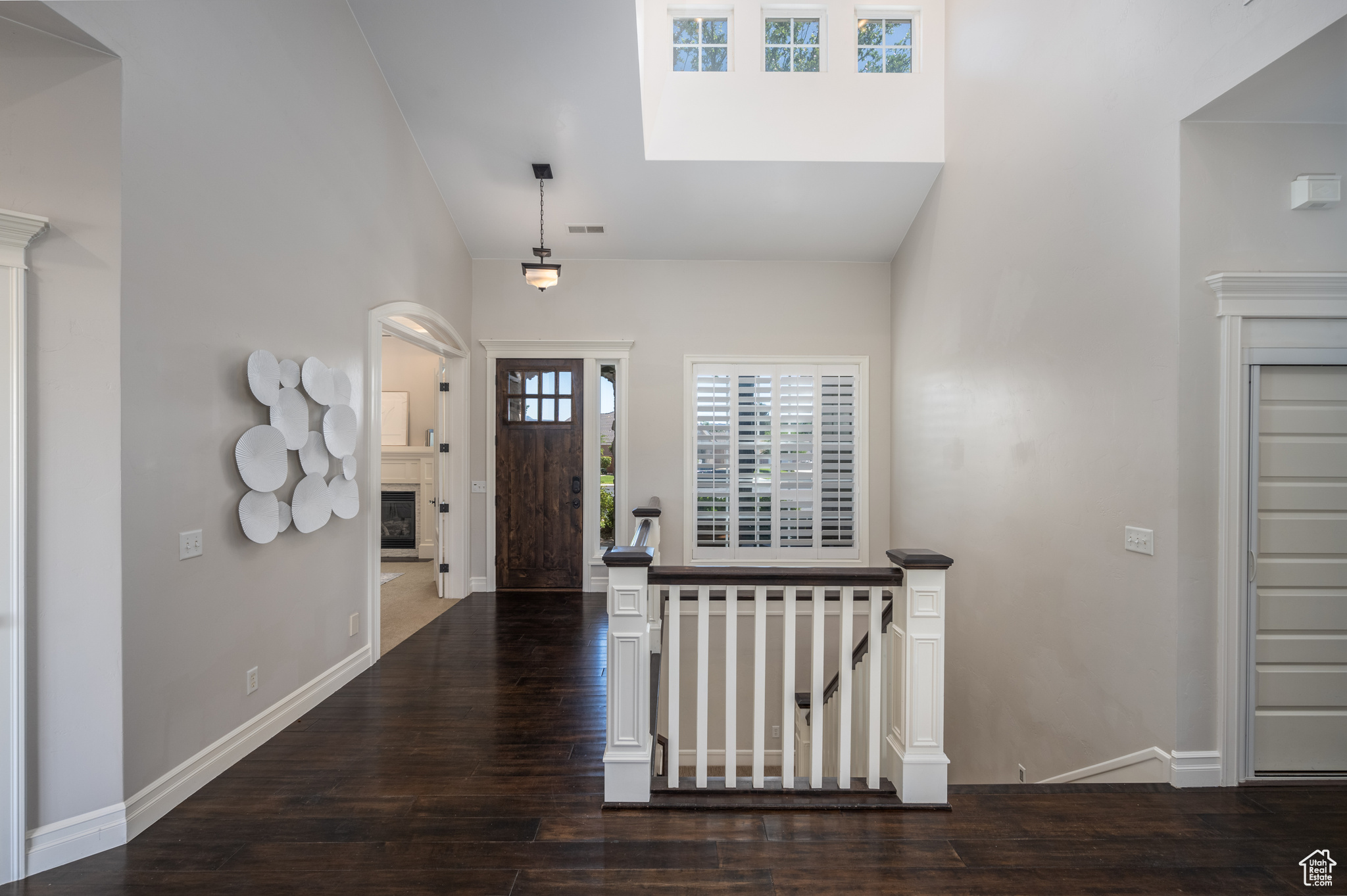 Foyer featuring dark hardwood / wood-style flooring and a high ceiling