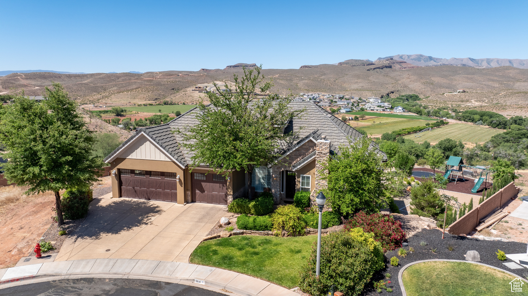 View of front facade featuring a garage and a mountain view