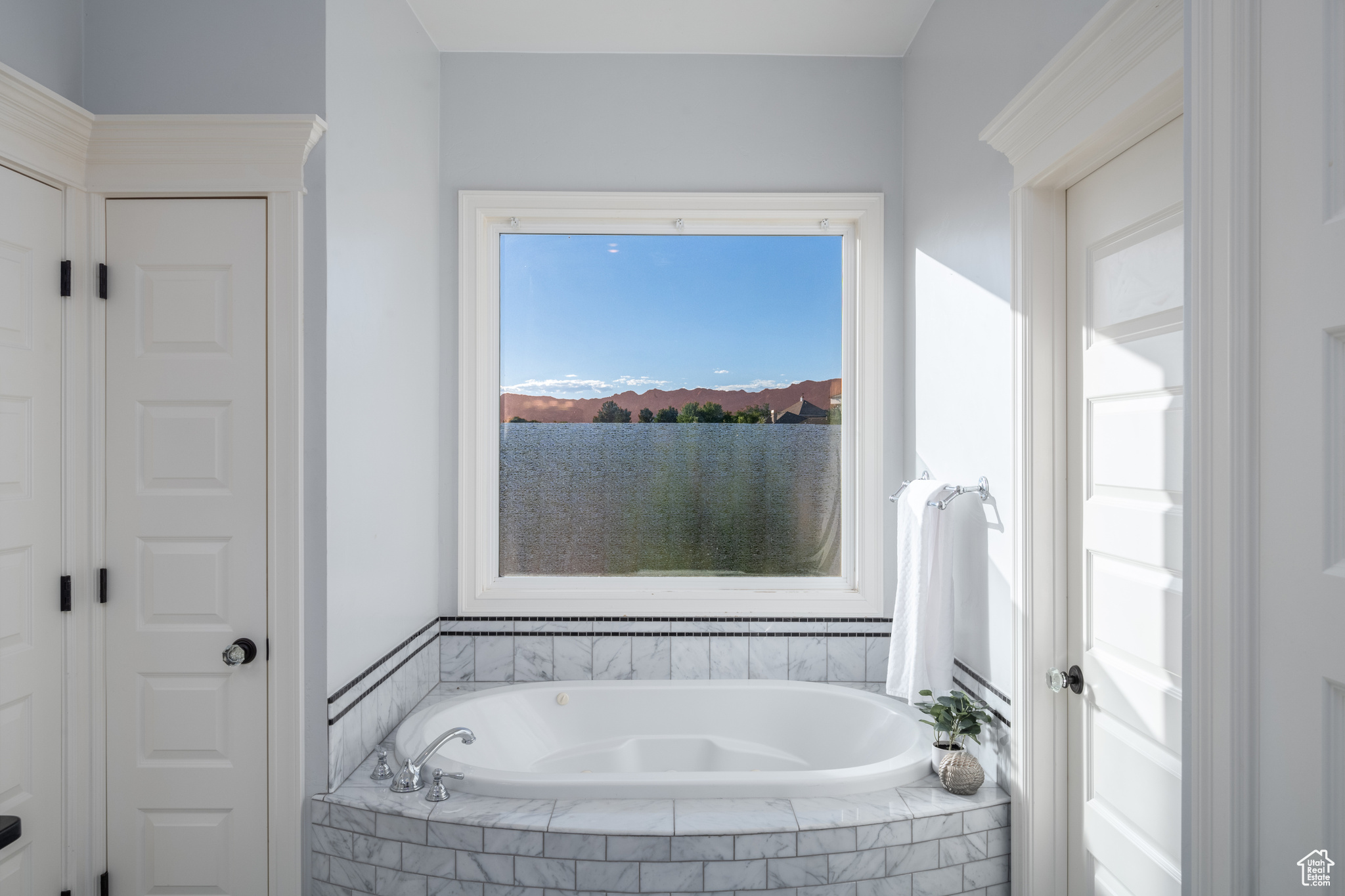 Bathroom with a view of red rocks.