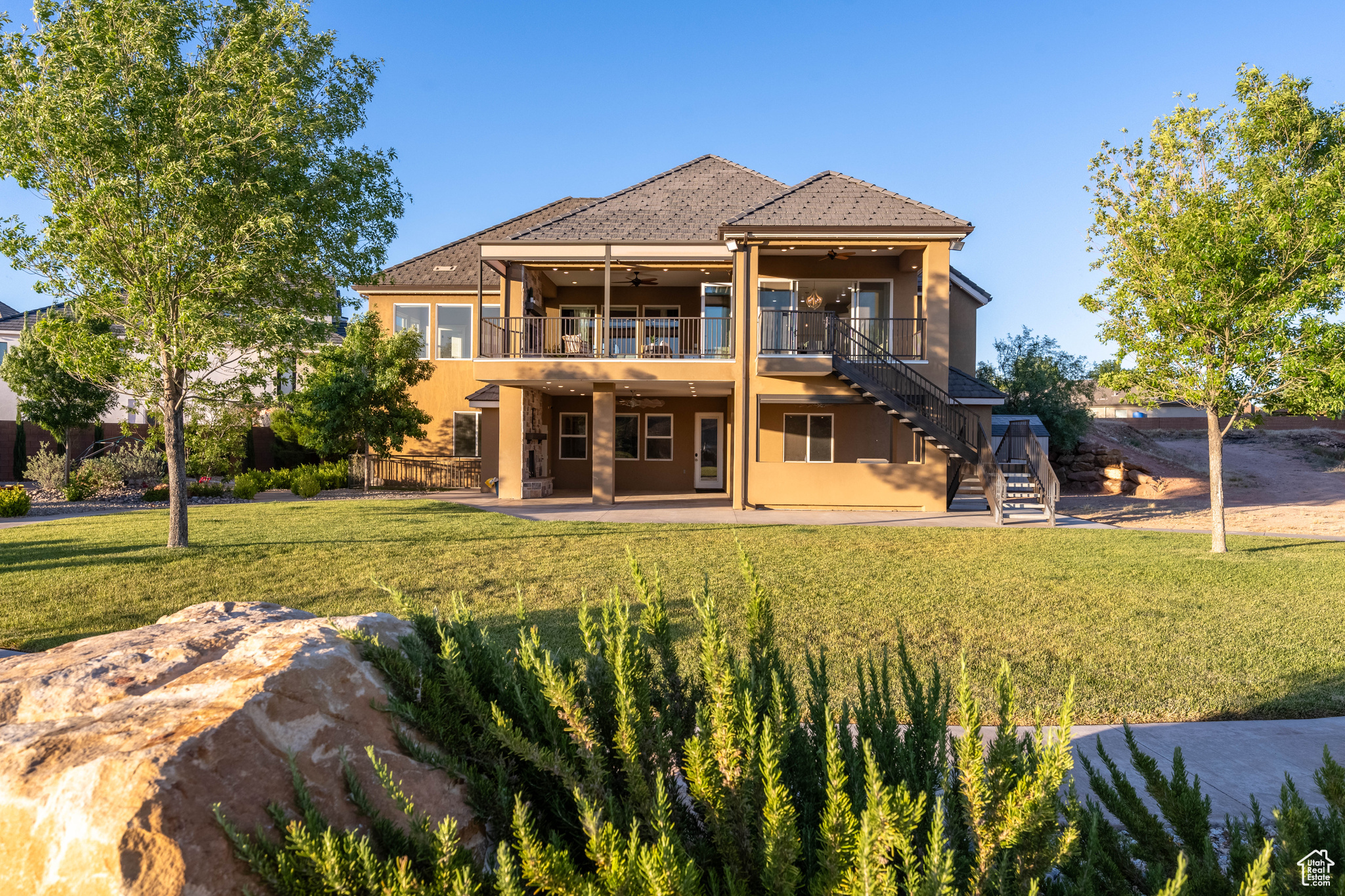 Back of property featuring a patio and a lawn