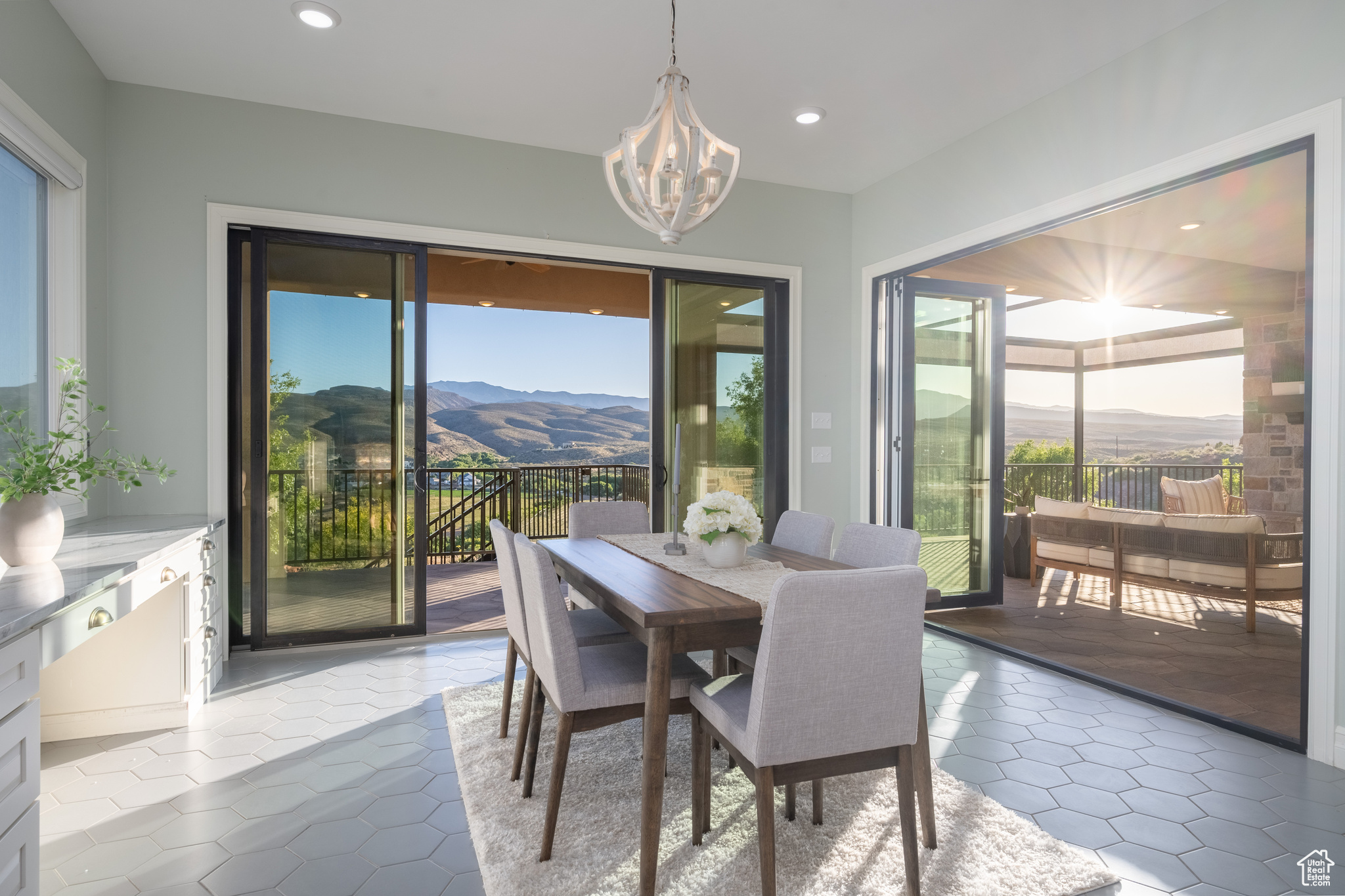 Dining area with light tile floors, a mountain view, and an inviting chandelier