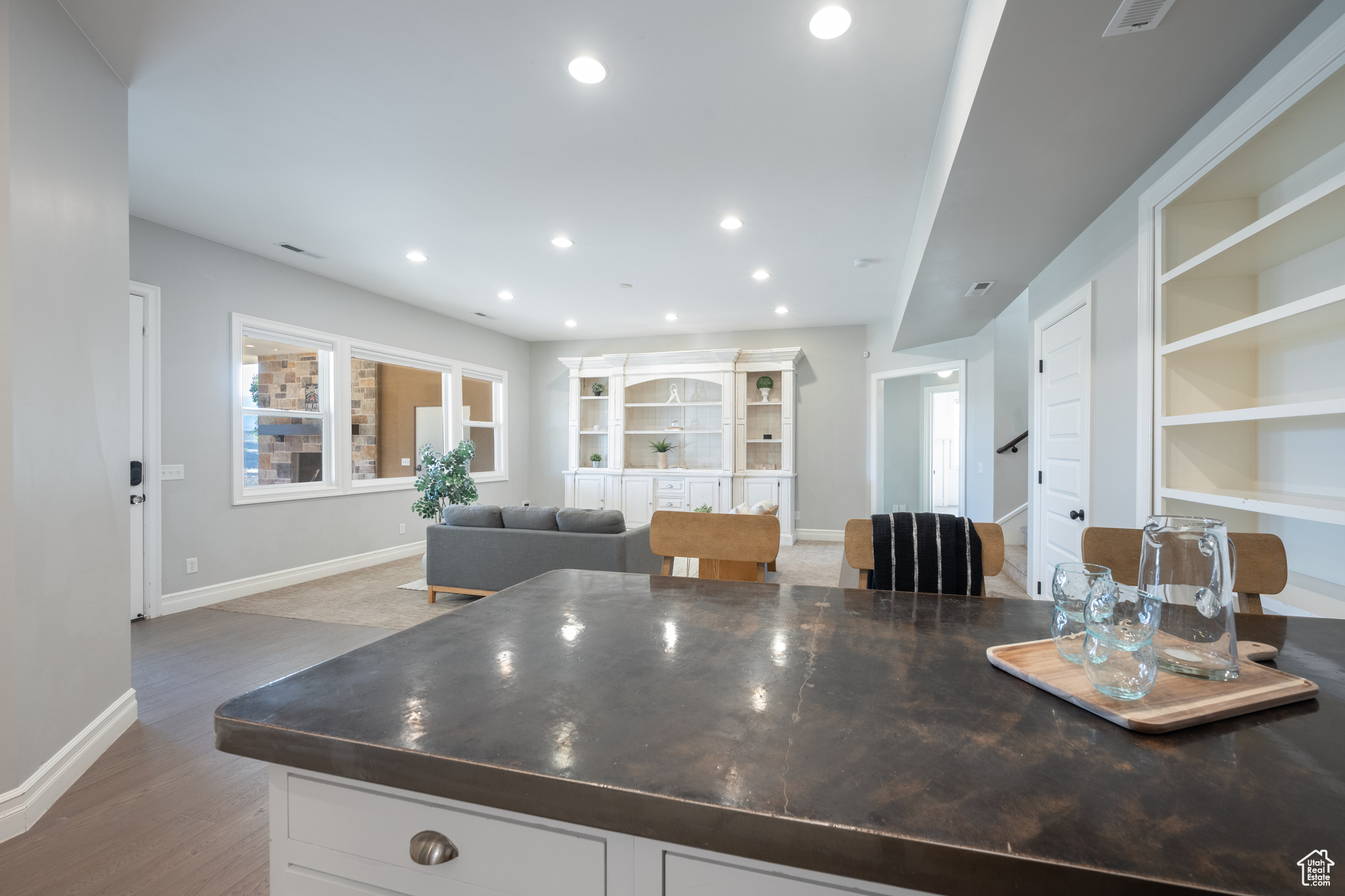 Kitchen with hardwood / wood-style floors and white cabinetry