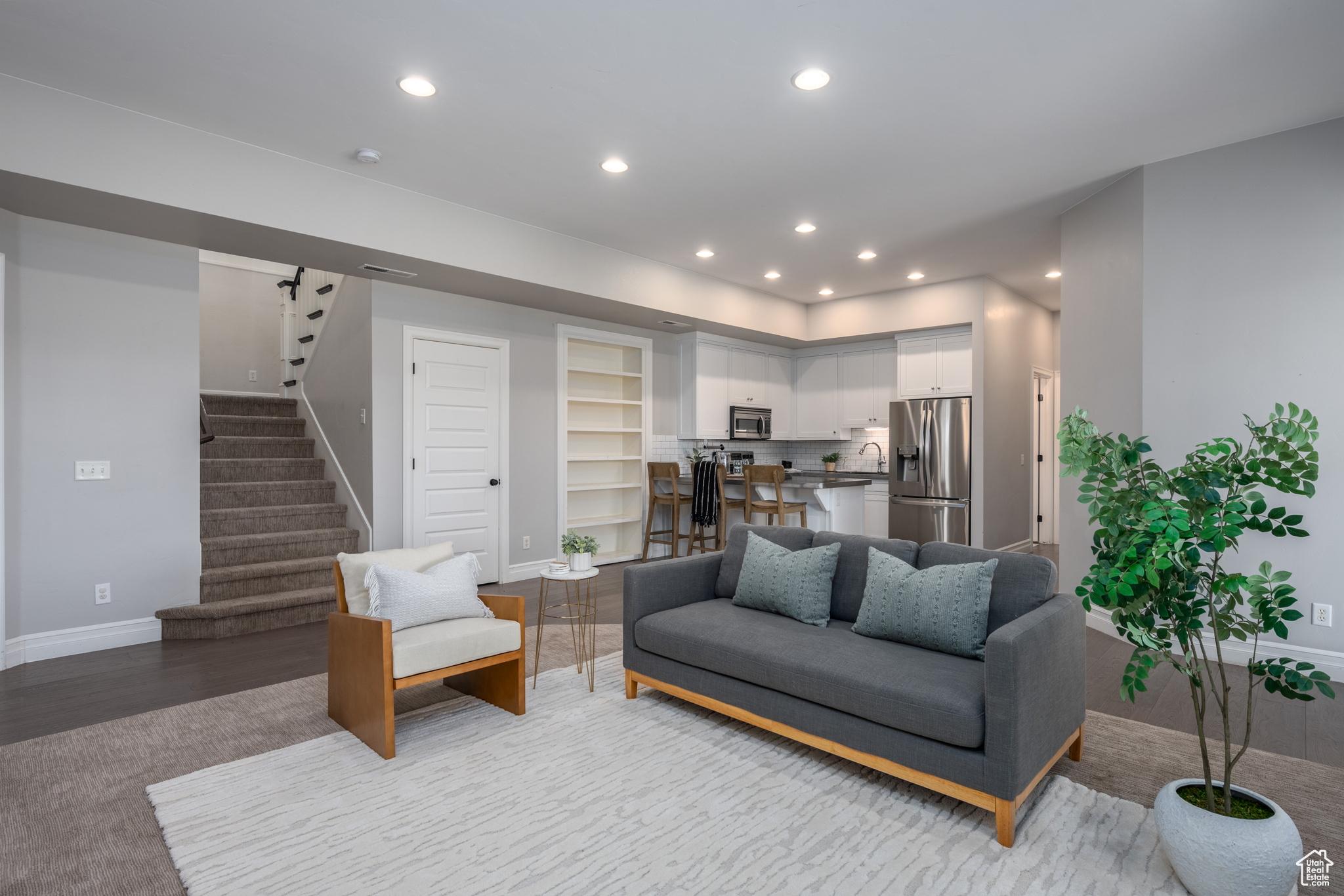 Living room featuring sink and light hardwood / wood-style flooring