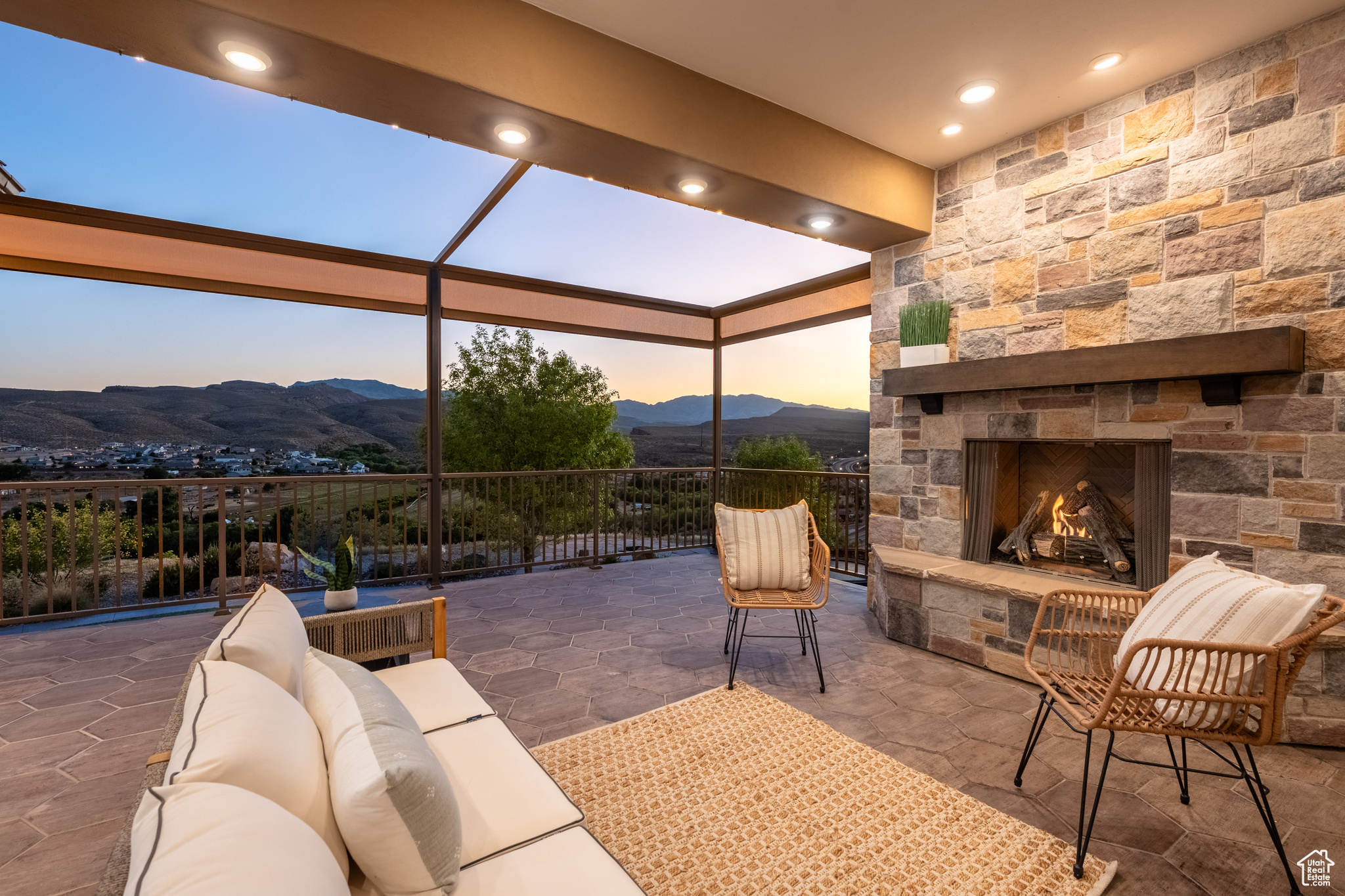 Patio terrace at dusk featuring a mountain view and an outdoor living space with a fireplace