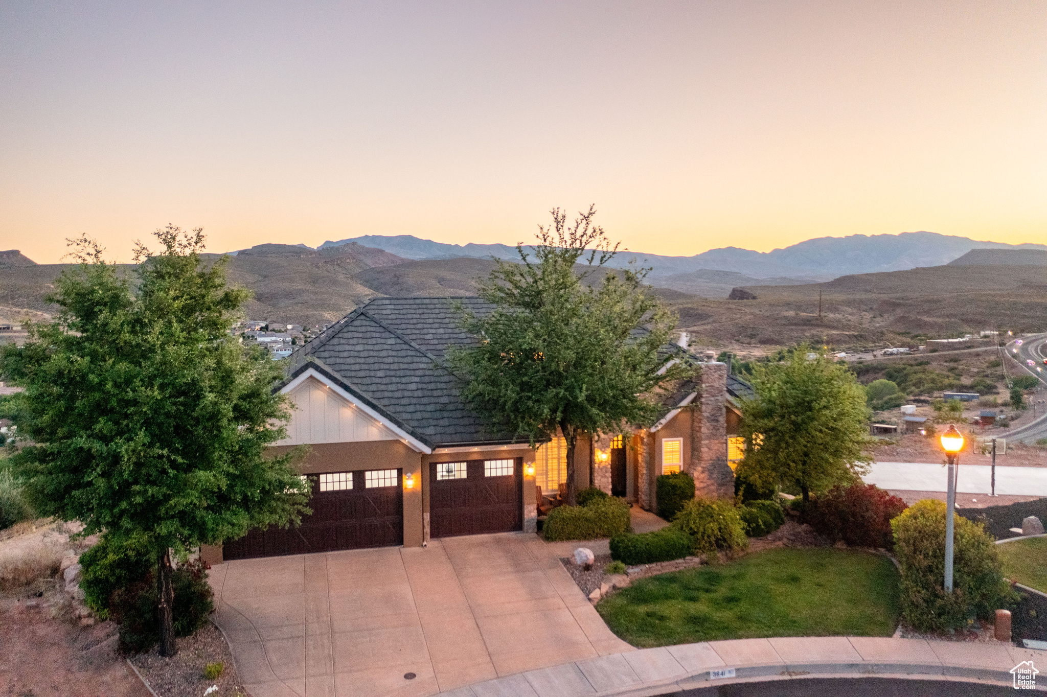 View of front facade with a garage and a mountain view