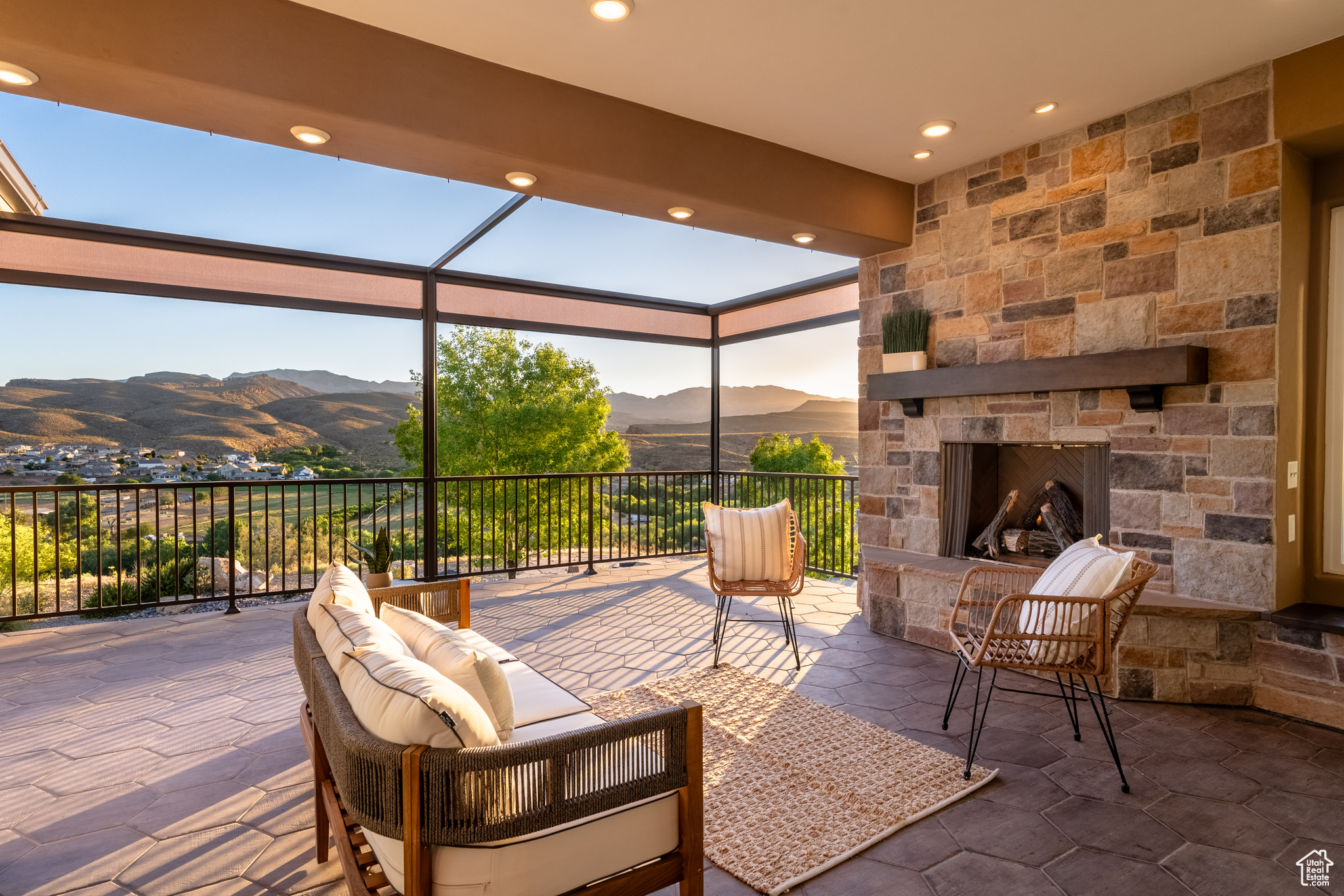 View of terrace featuring an outdoor stone fireplace and a mountain view