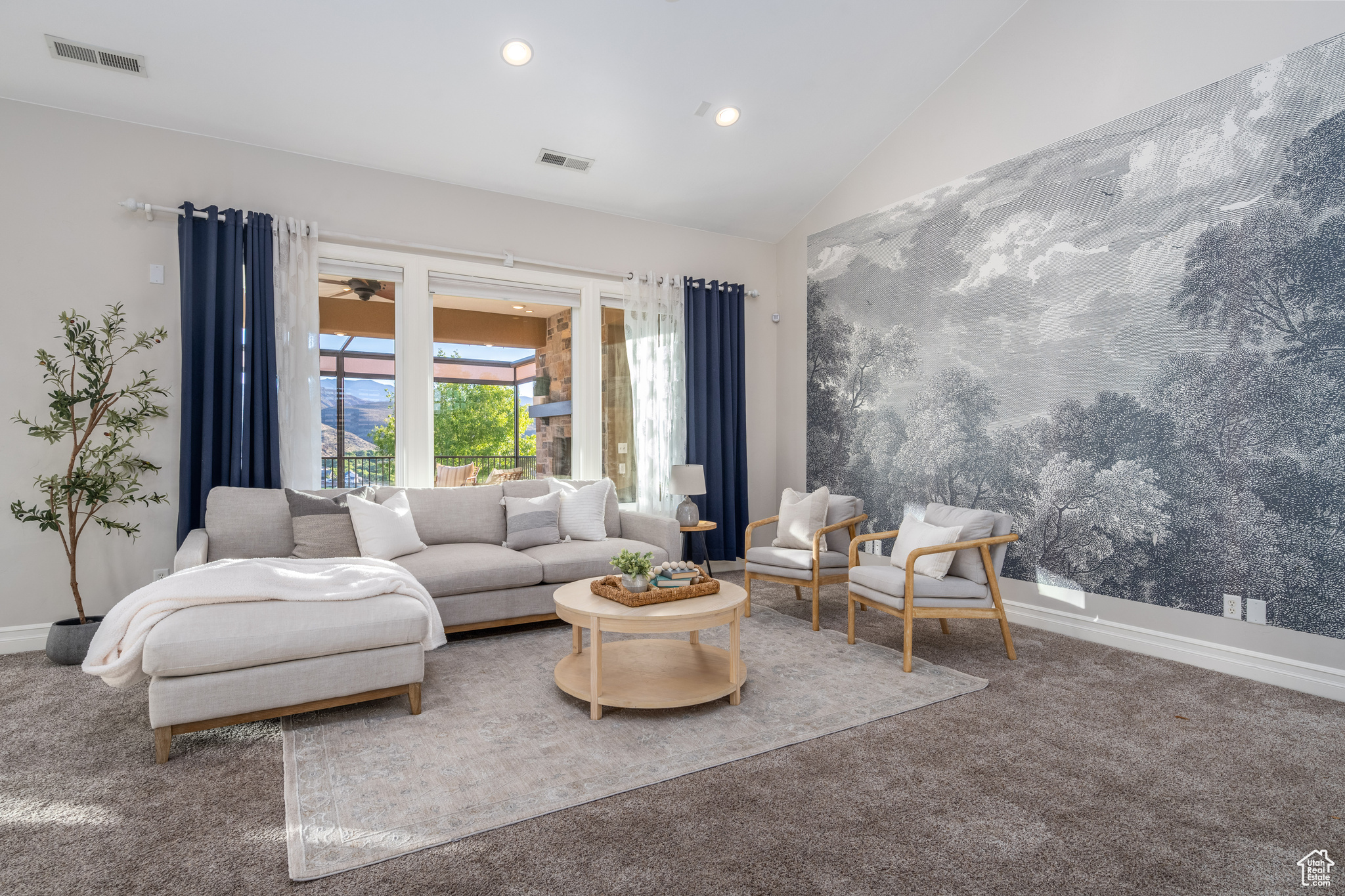 Living room with carpet floors and lofted ceiling