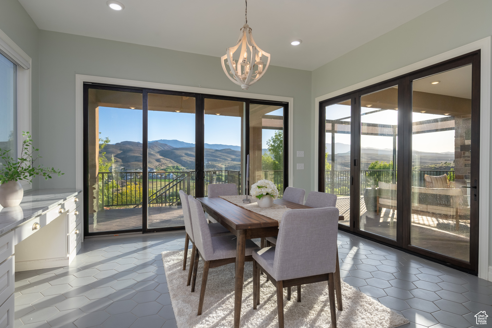 Dining room featuring tile flooring, a mountain view, and a chandelier