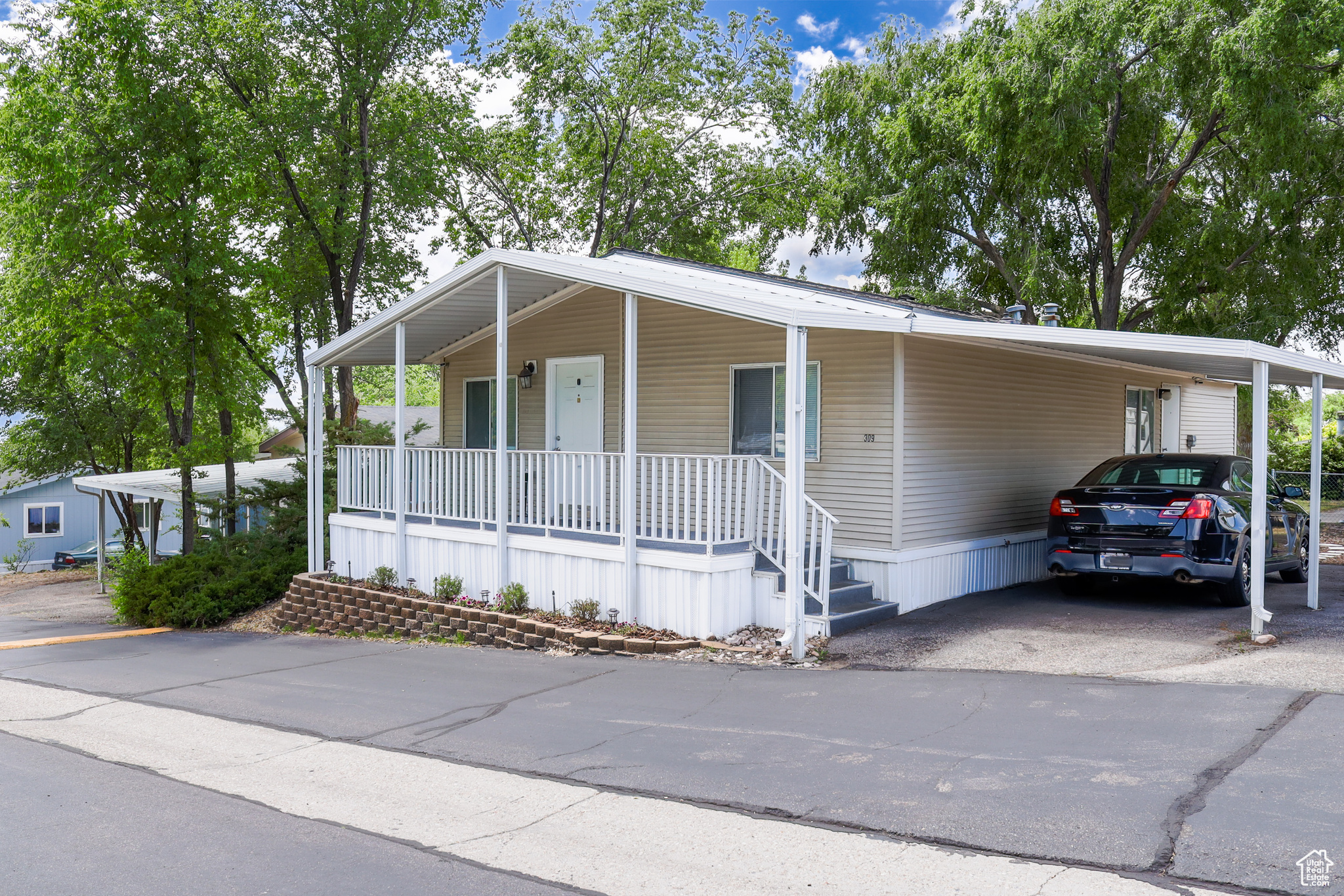 Manufactured / mobile home with a carport and a porch