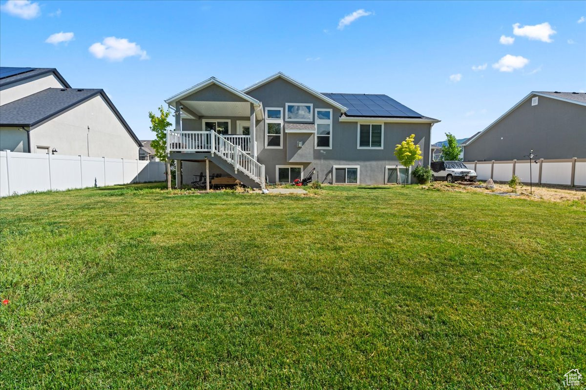 Rear view of house with a yard