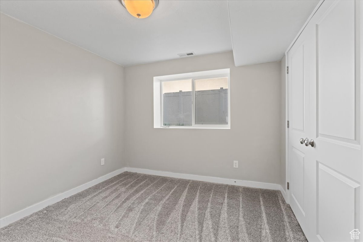 Unfurnished room with carpet floors