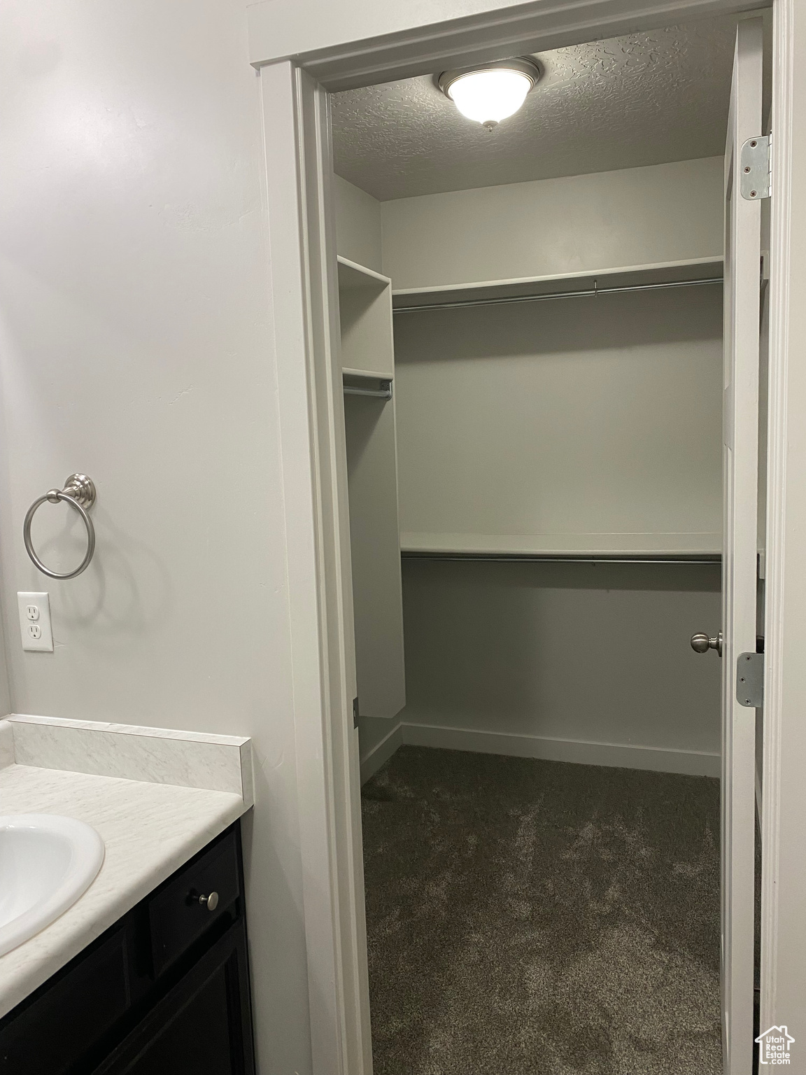 Bathroom with a textured ceiling and vanity