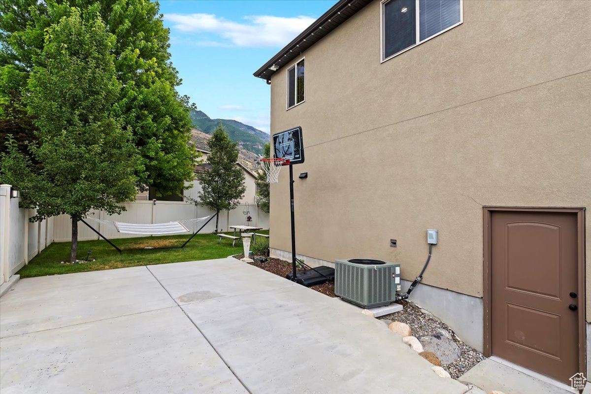View of patio / terrace featuring a mountain view and cooling unit