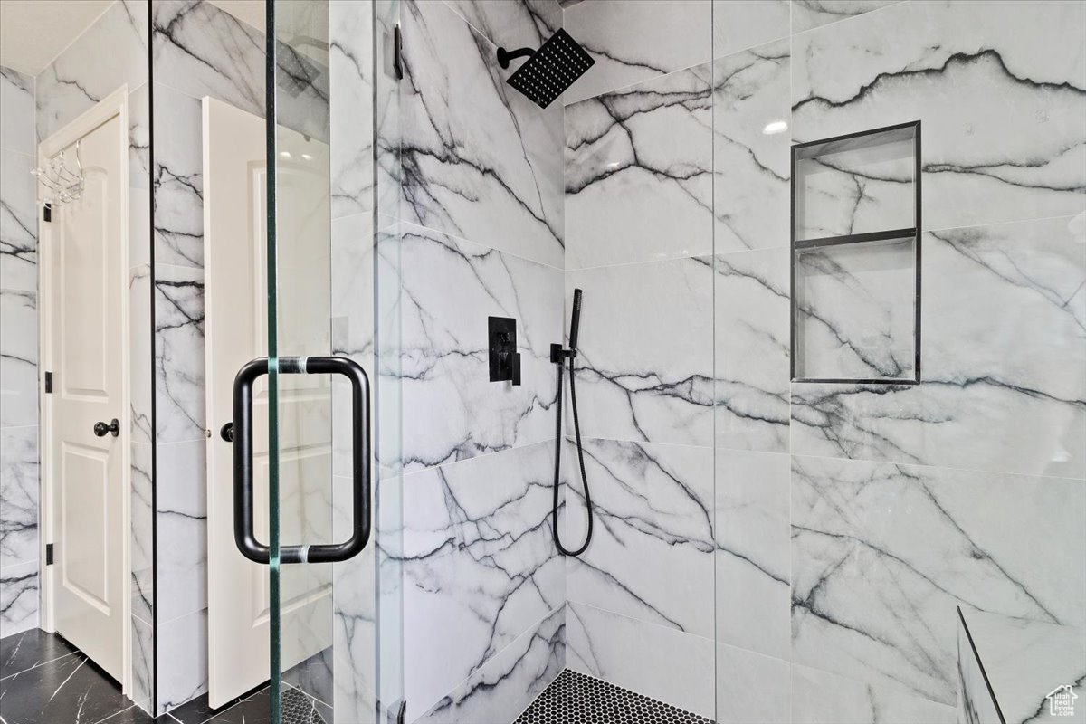 Bathroom with walk in shower and tile patterned flooring