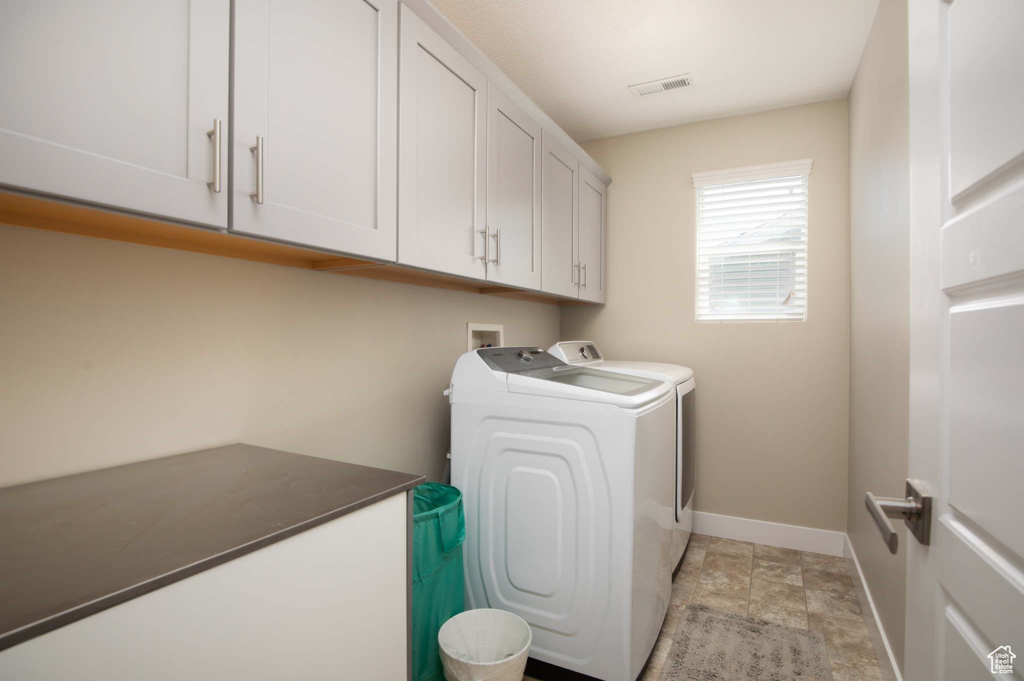 Laundry Room featuring washer and dryer, cabinets