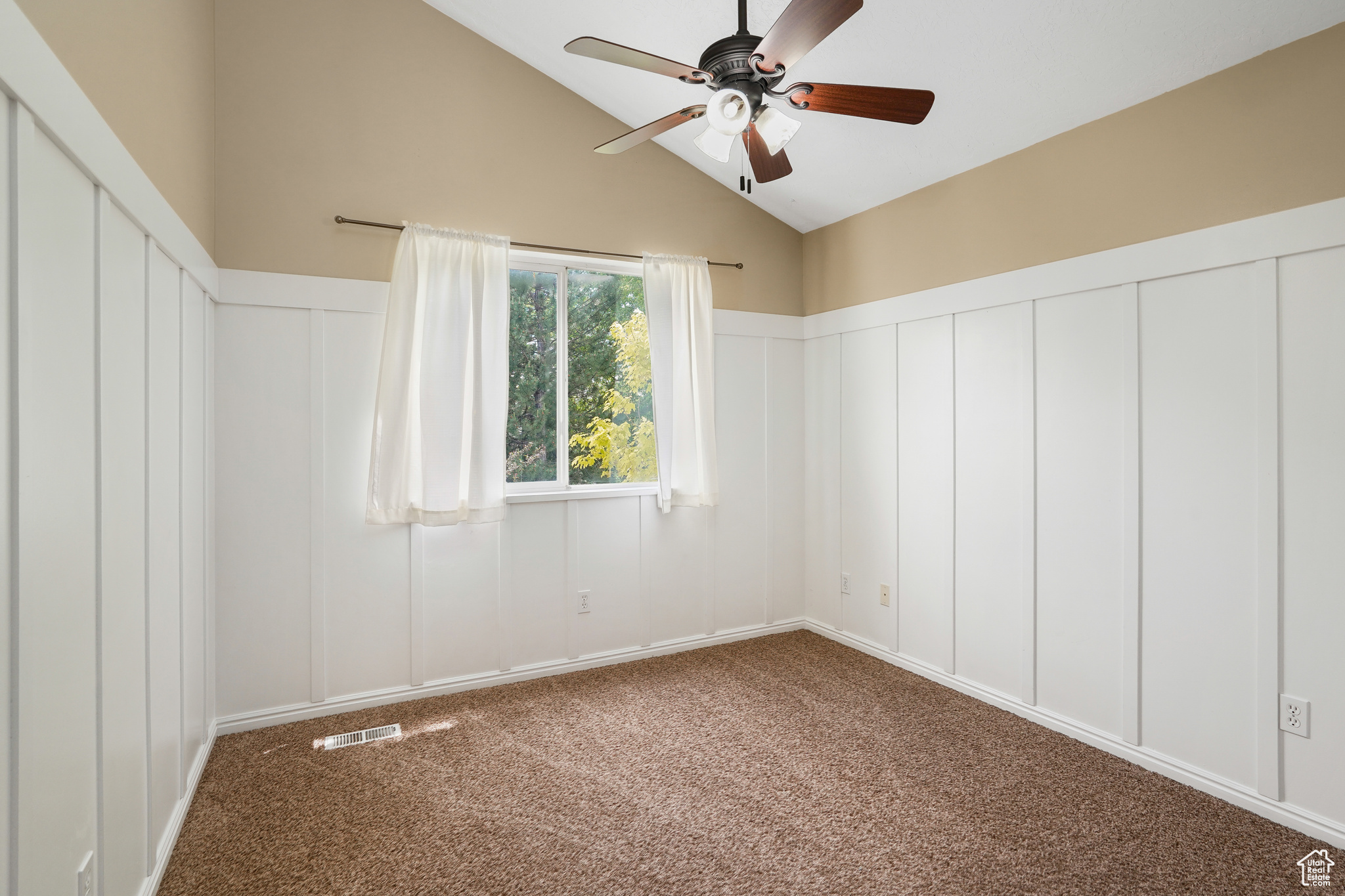 Carpeted spare room with high vaulted ceiling and ceiling fan