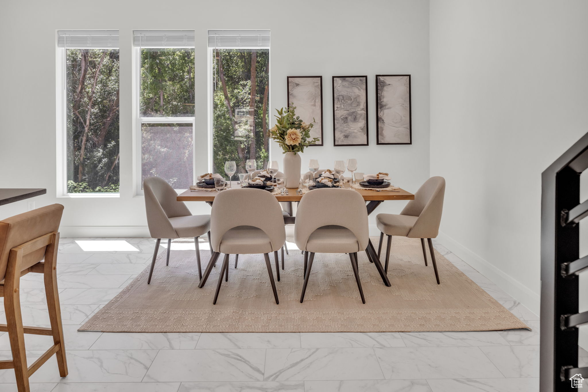 Dining space with a healthy amount of sunlight and light tile flooring