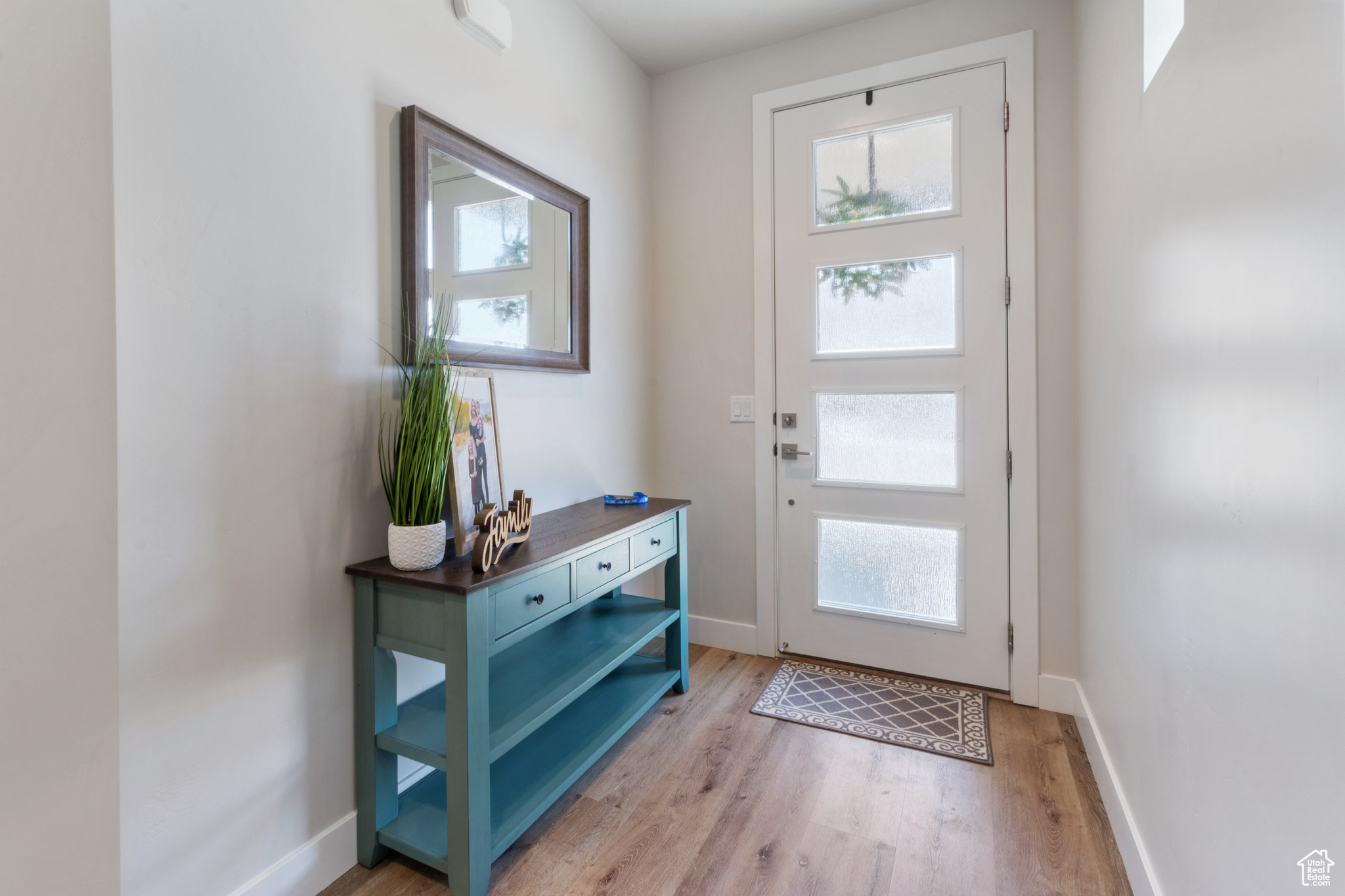 Entryway with a wealth of natural light and hardwood / wood-style floors