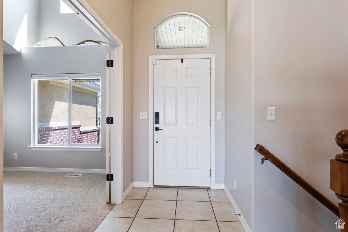 Entryway with light tile floors