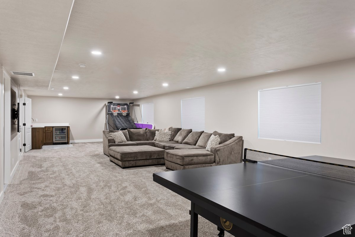 Rec room with light colored carpet