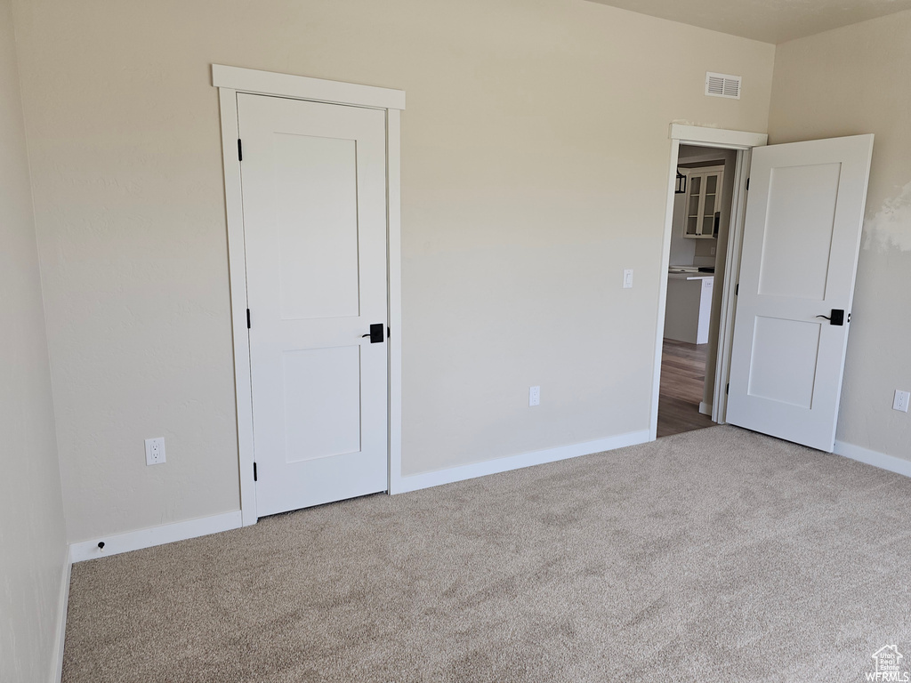 Unfurnished bedroom with carpet floors