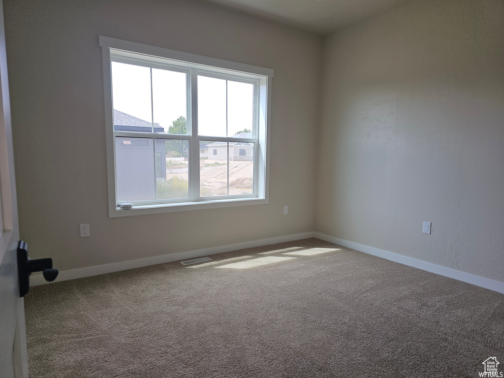 Empty room with carpet floors