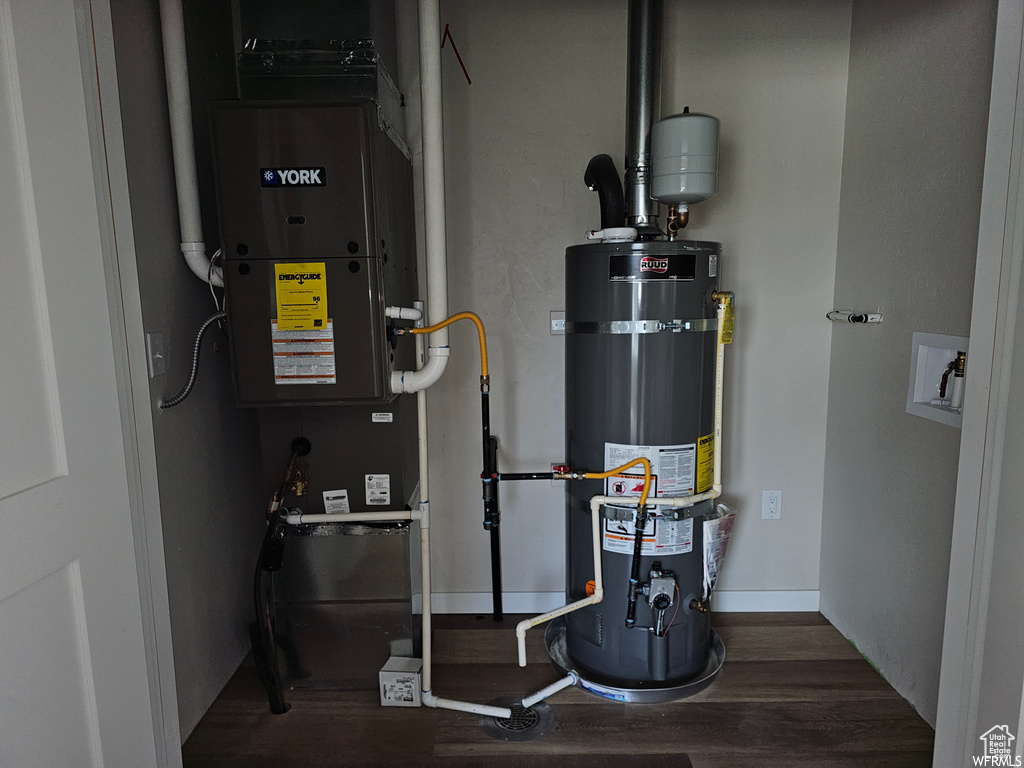 Utility room featuring water heater and heating utilities