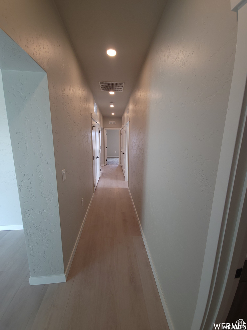 Hall with hardwood / wood-style flooring