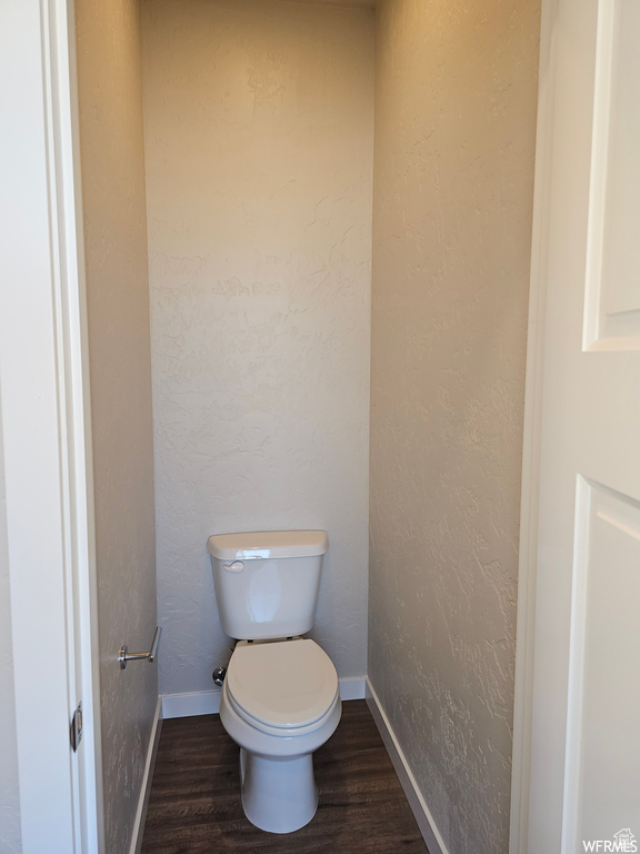 Bathroom featuring hardwood / wood-style flooring and toilet