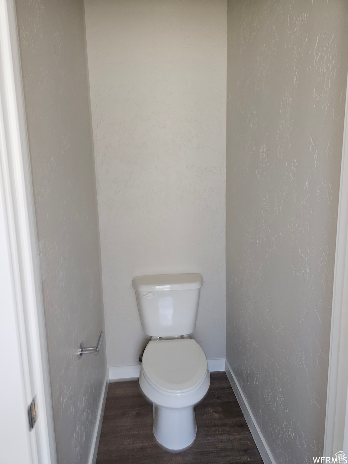 Bathroom featuring toilet and wood-type flooring