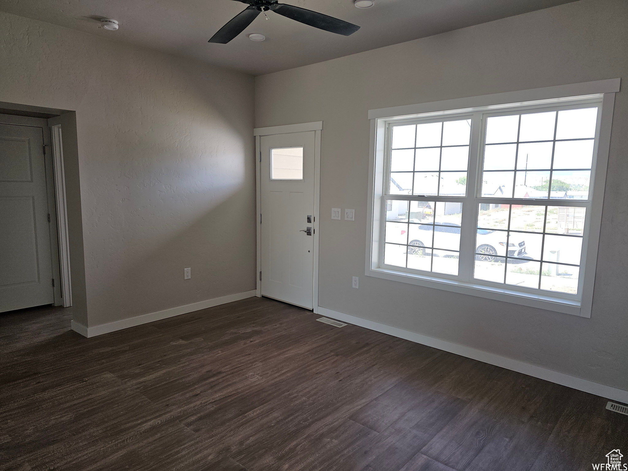 Foyer featuring dark hardwood / wood-style floors and ceiling fan