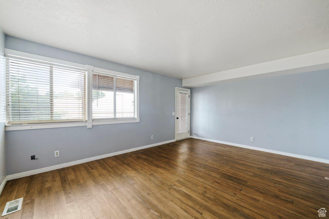 Family room with a textured ceiling and wood-type flooring