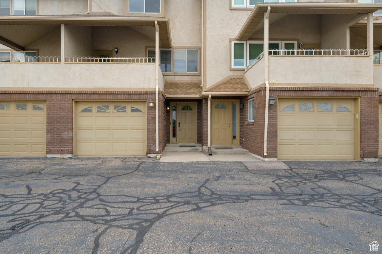 View of front facade with a garage and a balcony