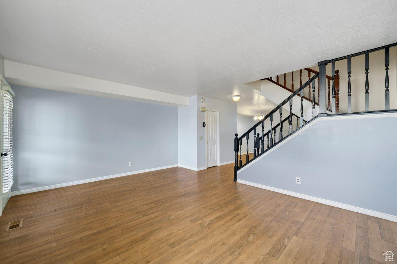 Living room featuring a textured ceiling and hardwood / wood-style flooring